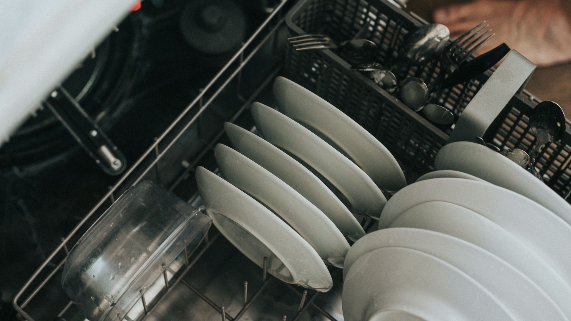 white ceramic plate on black dishwasher