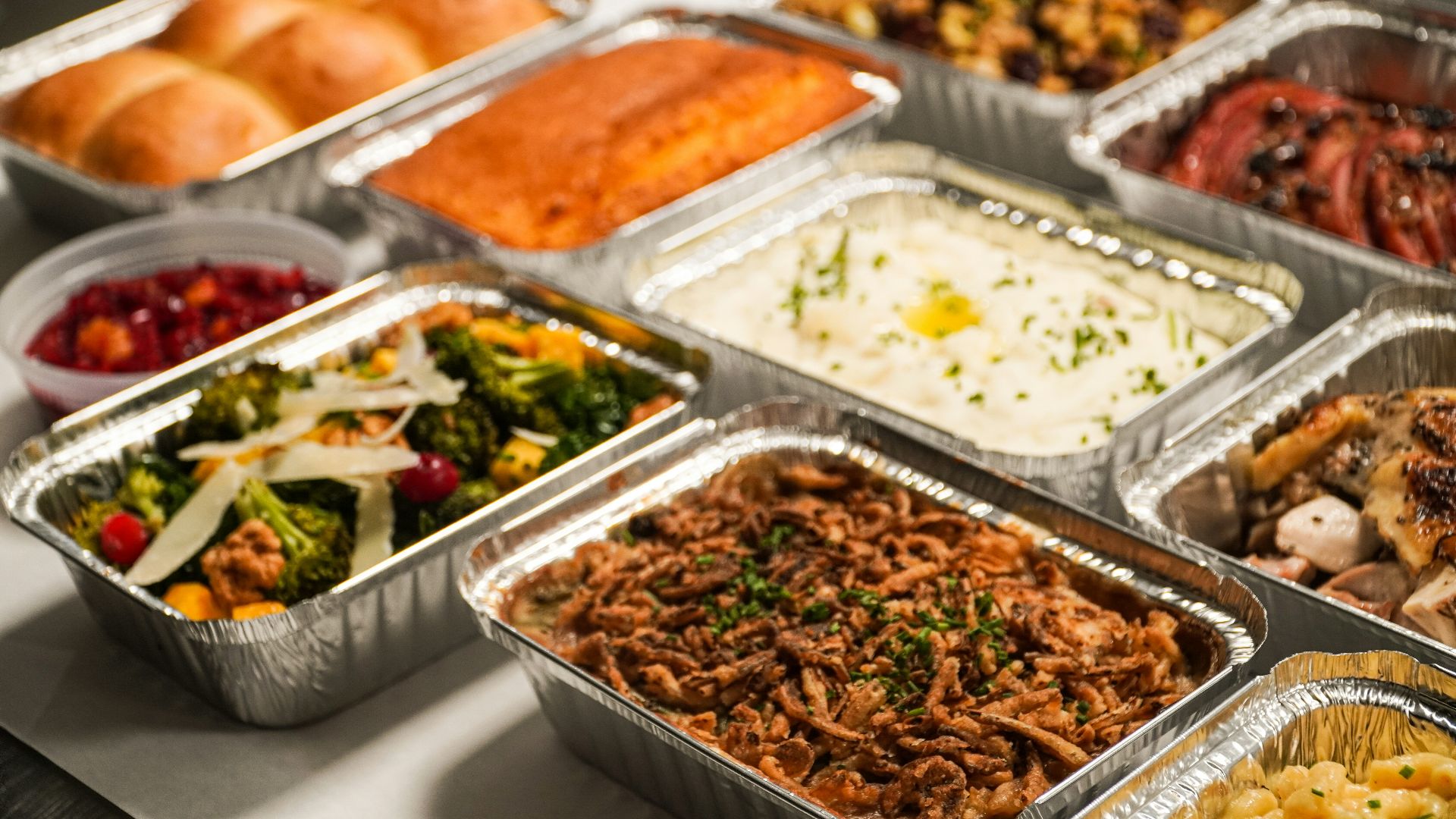 a table topped with lots of trays of food