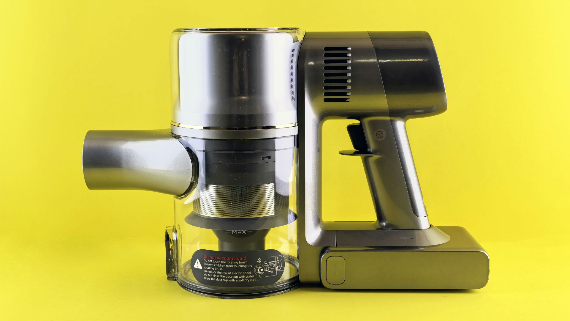 A modern cordless vacuum against a yellow backdrop.
