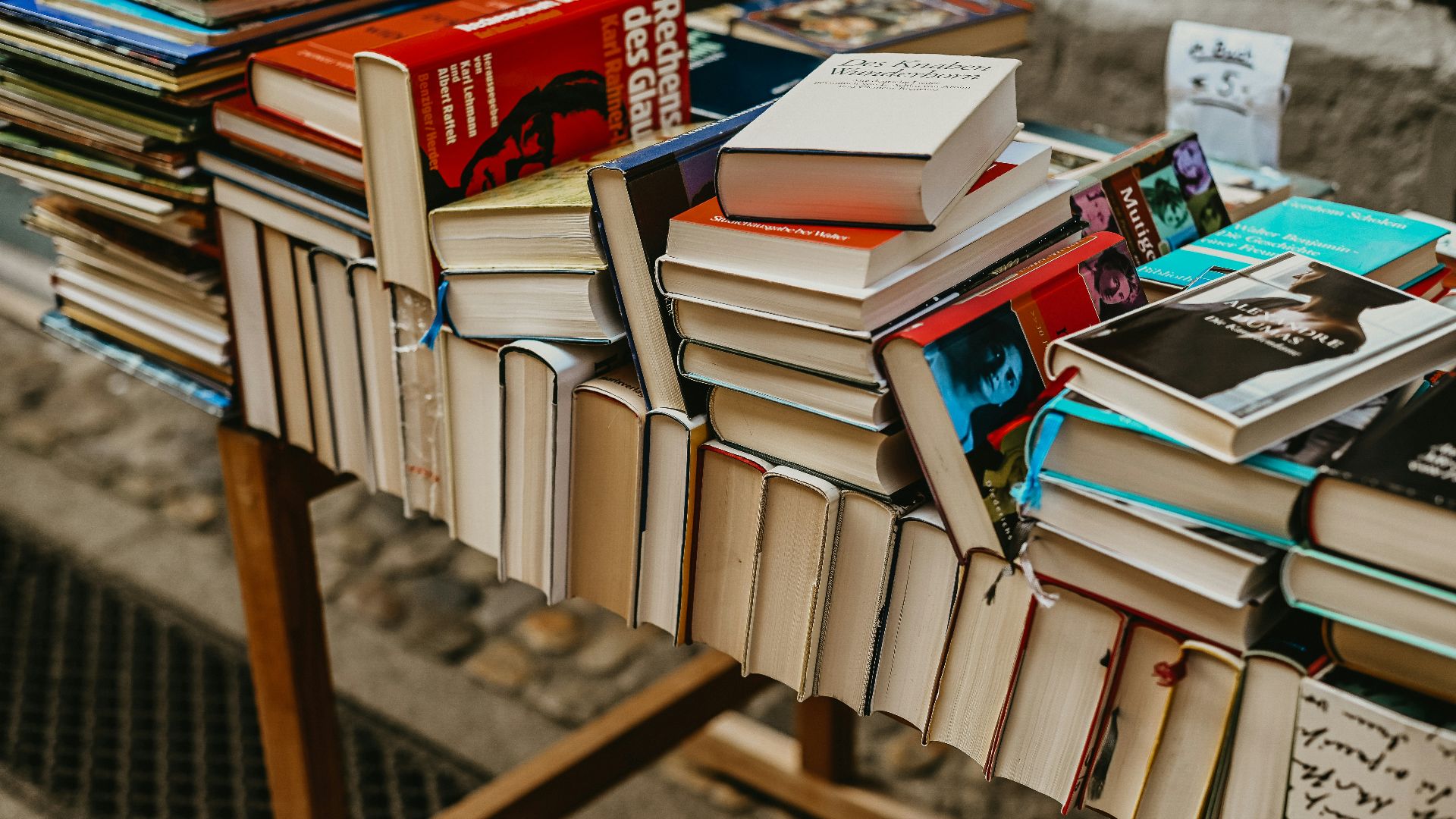 a pile of books sitting on top of a wooden table