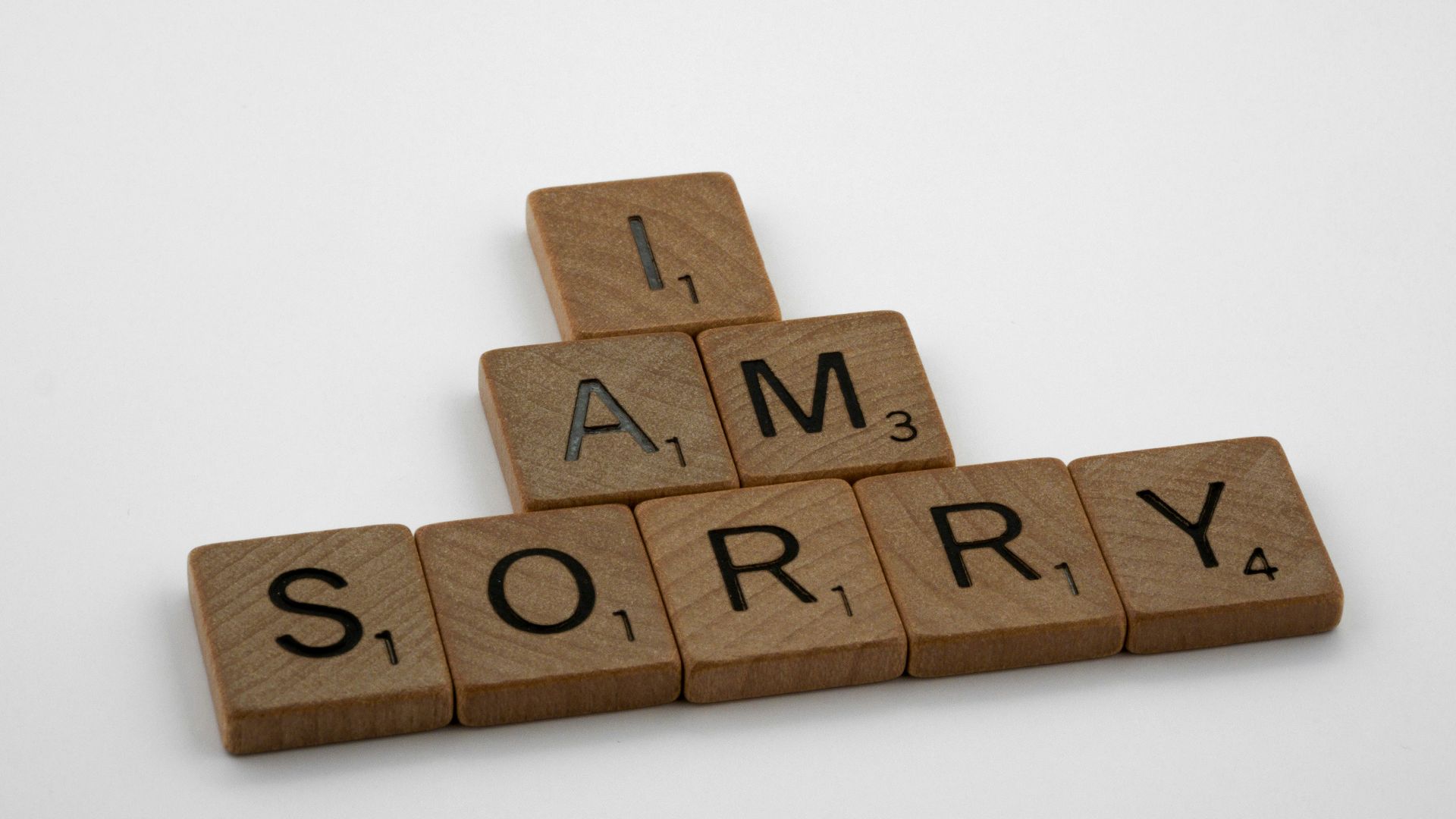 brown wooden letter blocks on white surface