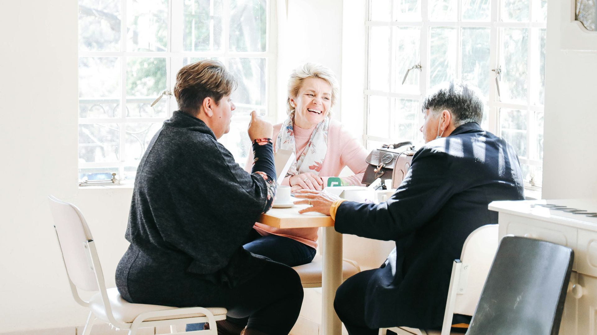 a group of people sitting around a table