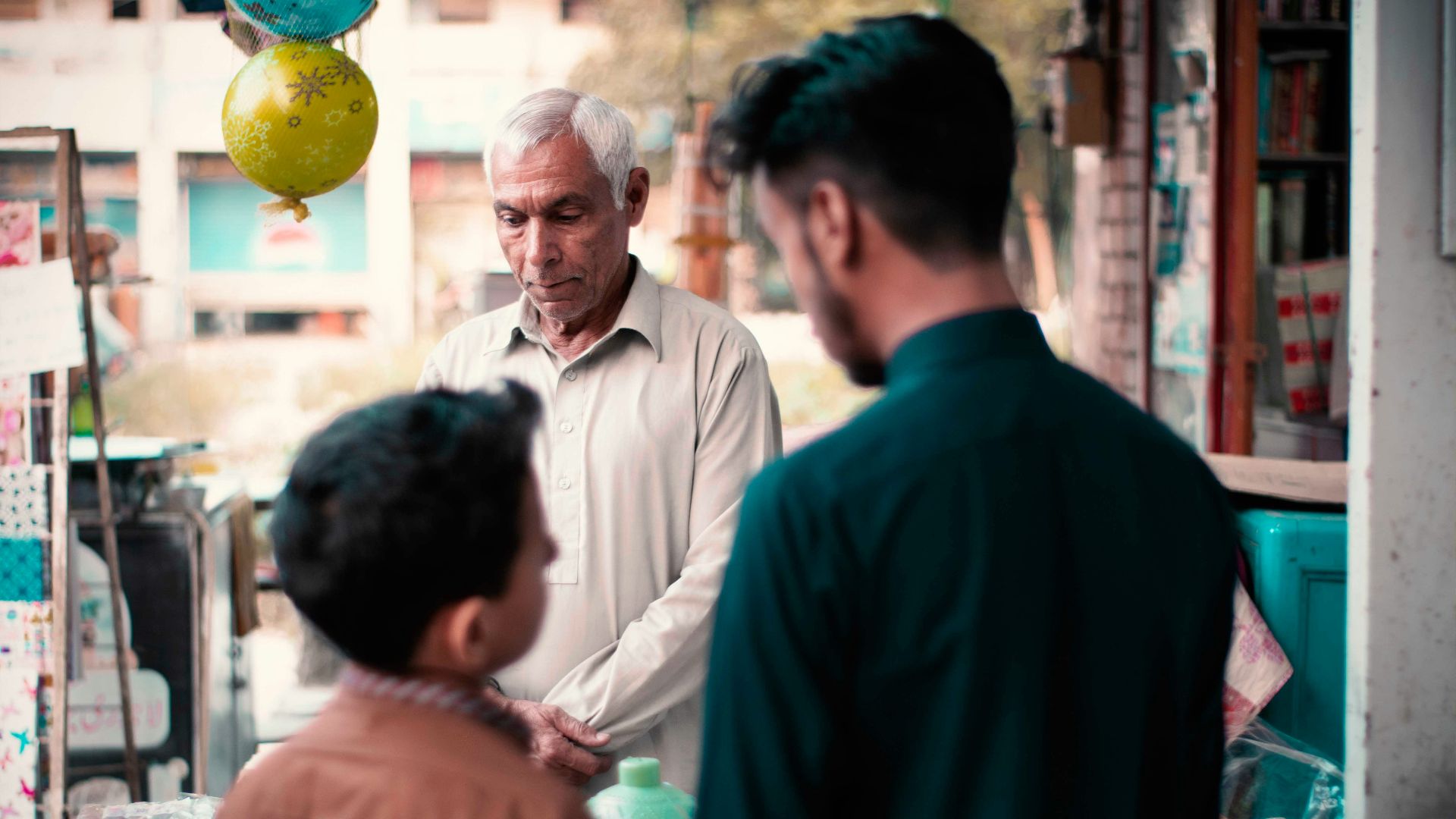 man in black suit standing in front of man in white dress shirt