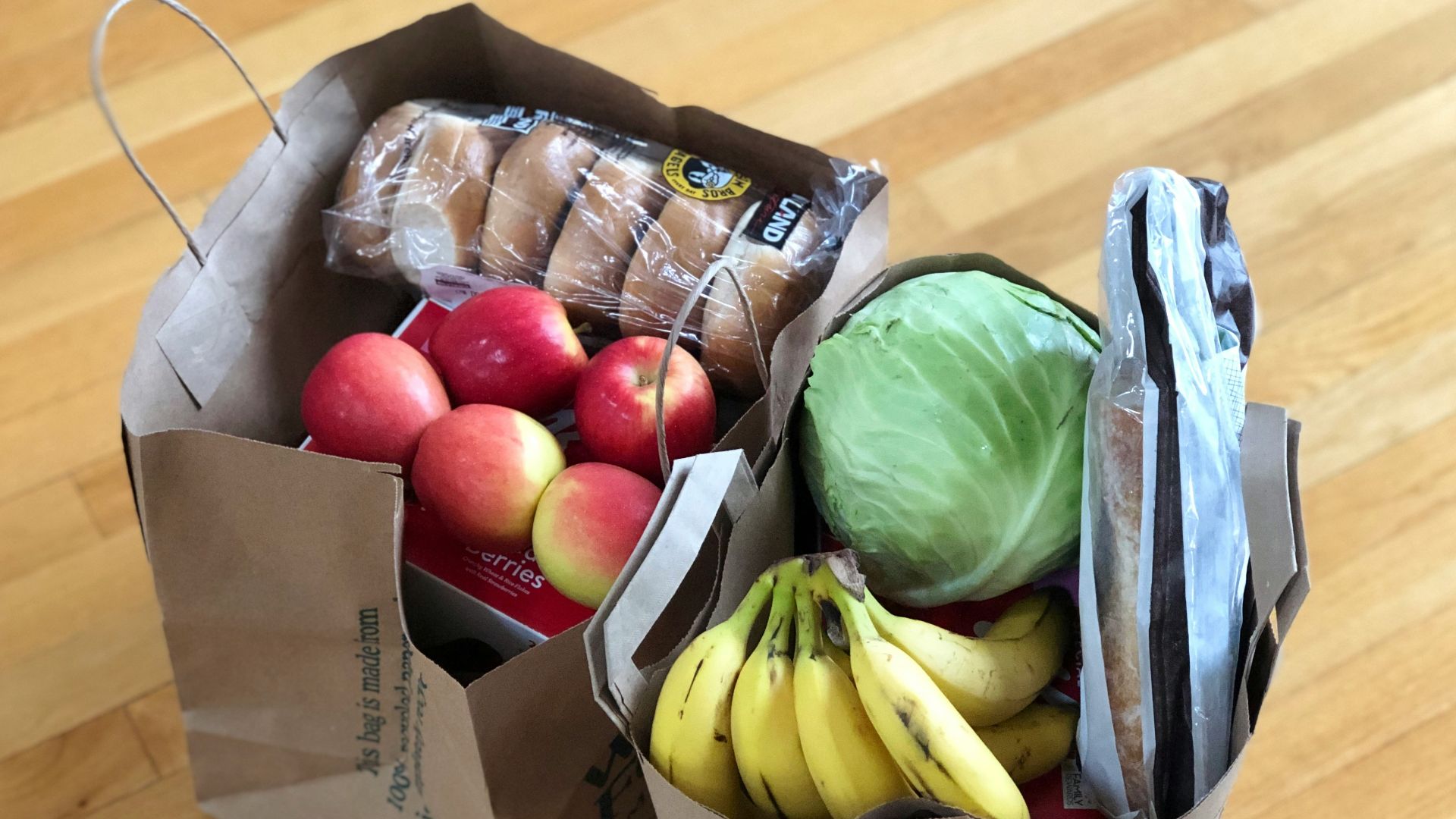 apples and bananas in brown cardboard box
