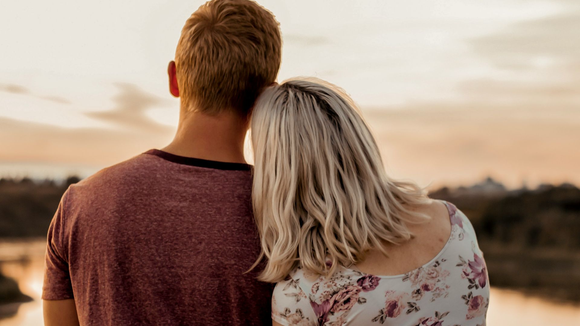 man and woman standing on brown field during daytime