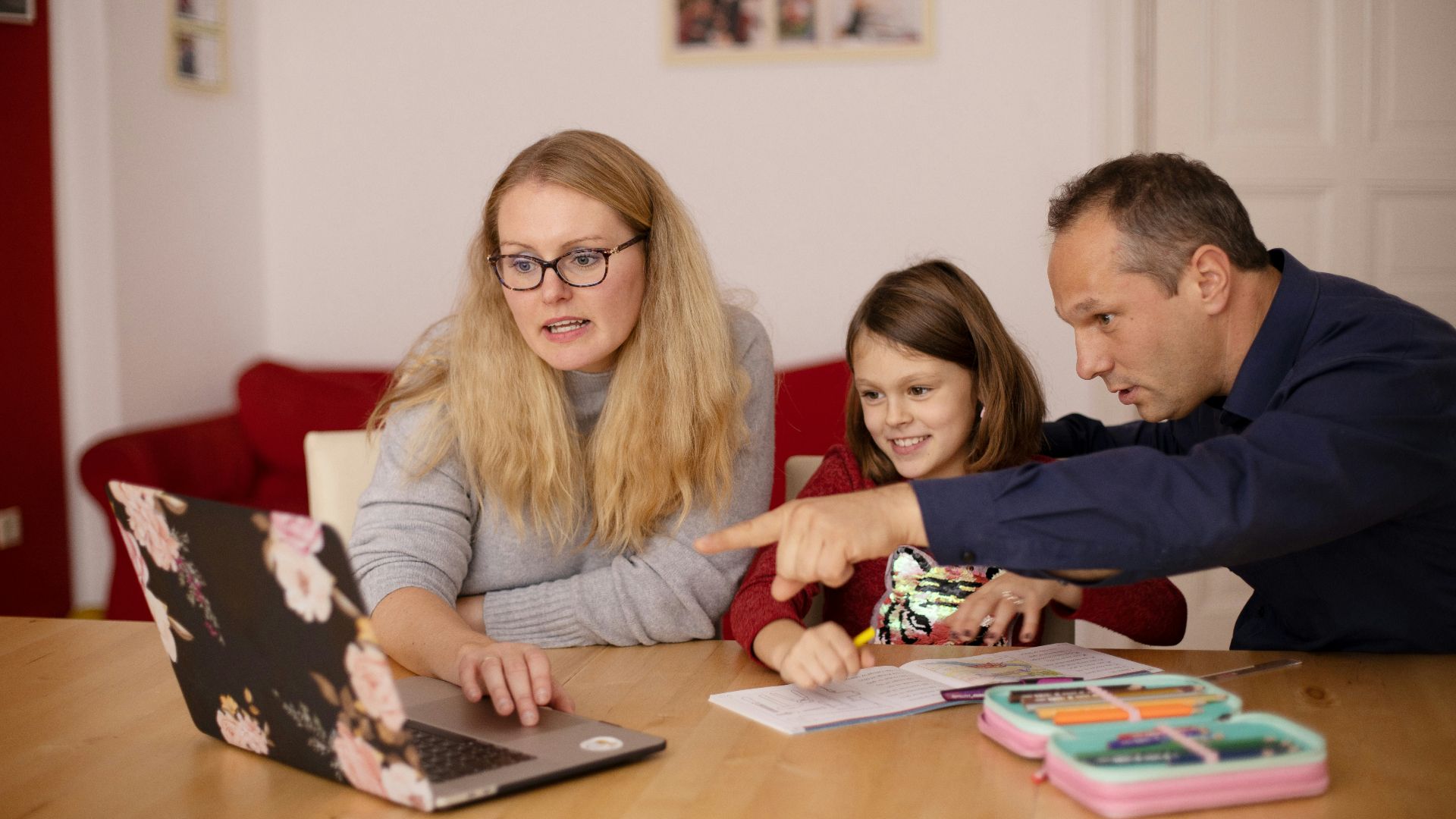 woman in gray long sleeve shirt sitting beside boy in blue sweater