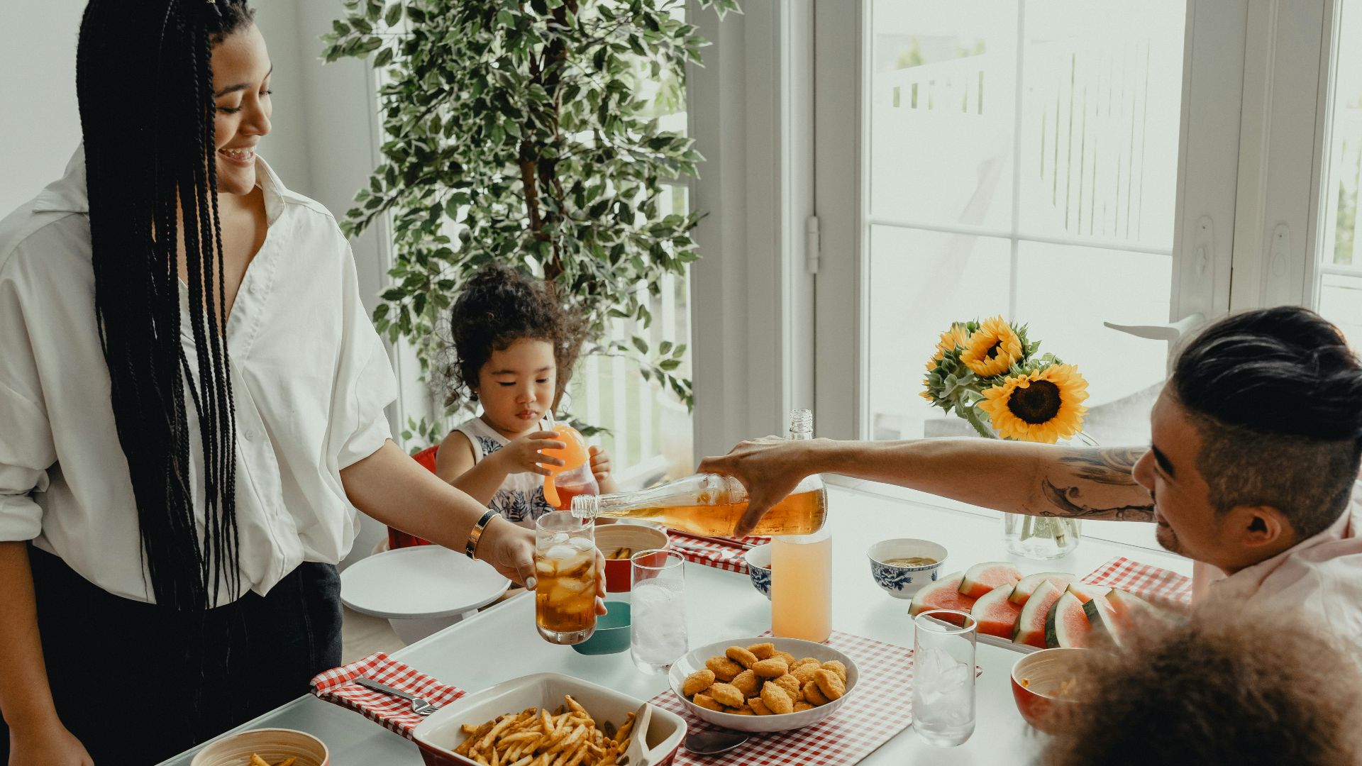 woman in white shirt holding a girl in white shirt
