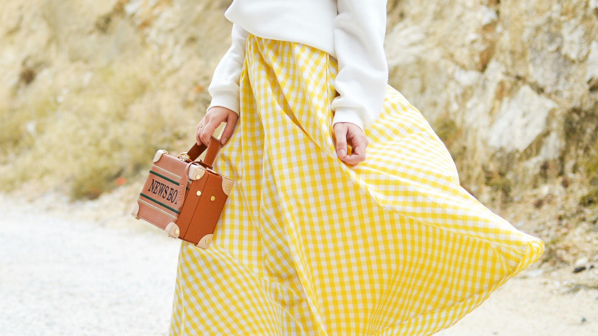 woman in yellow and white checked skirt