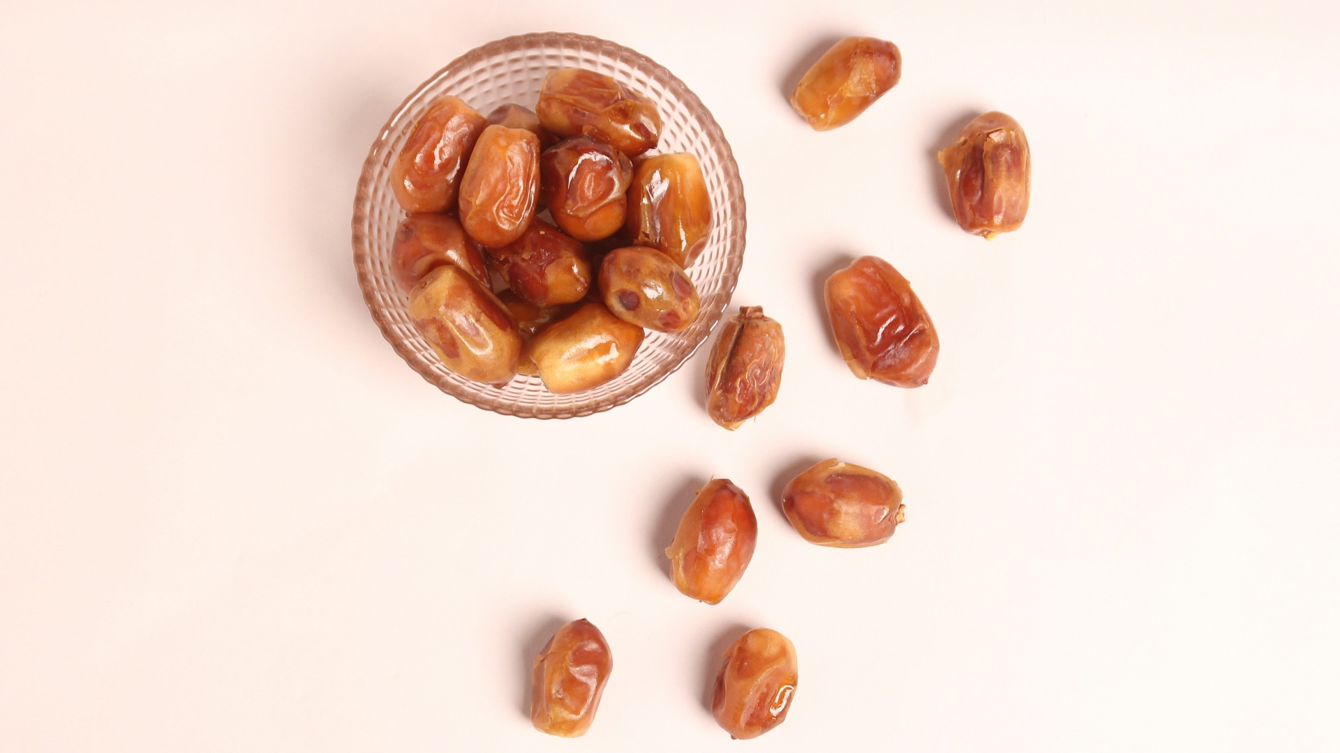 a glass bowl filled with nuts on top of a table