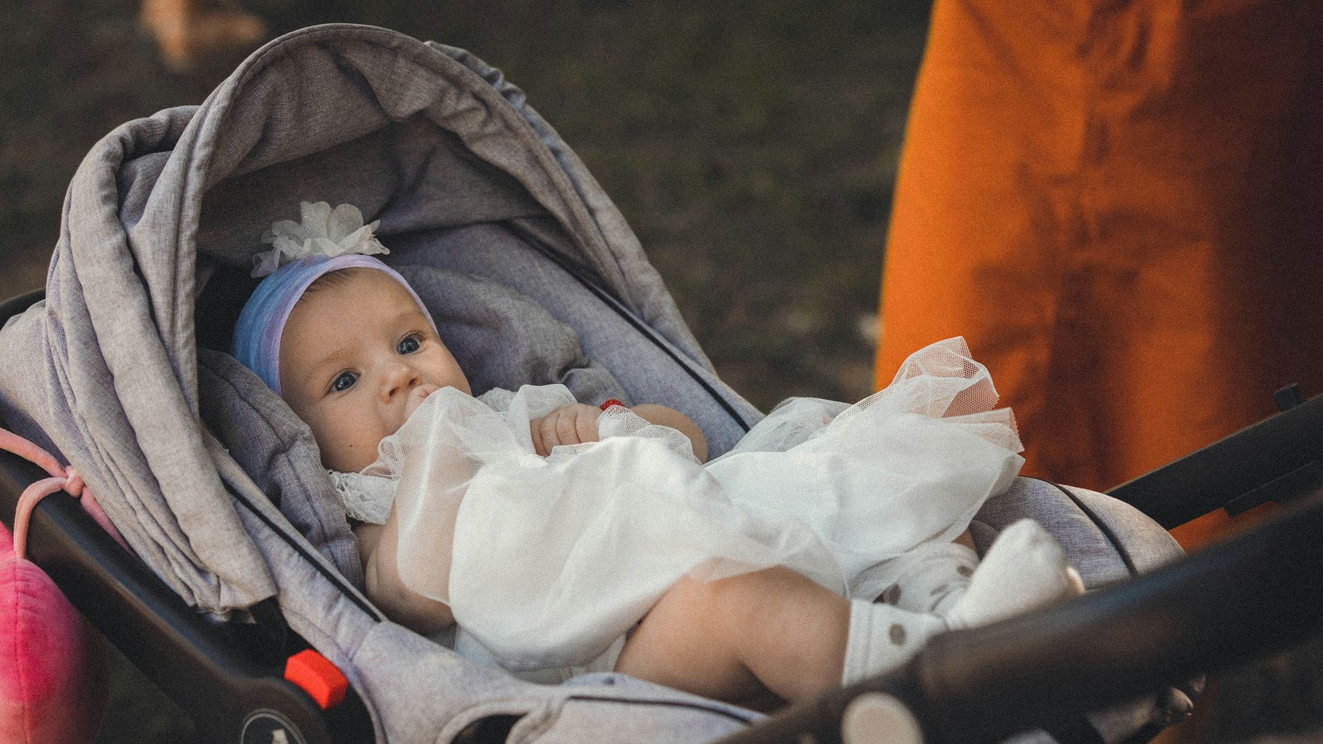 a baby is sitting in a stroller
