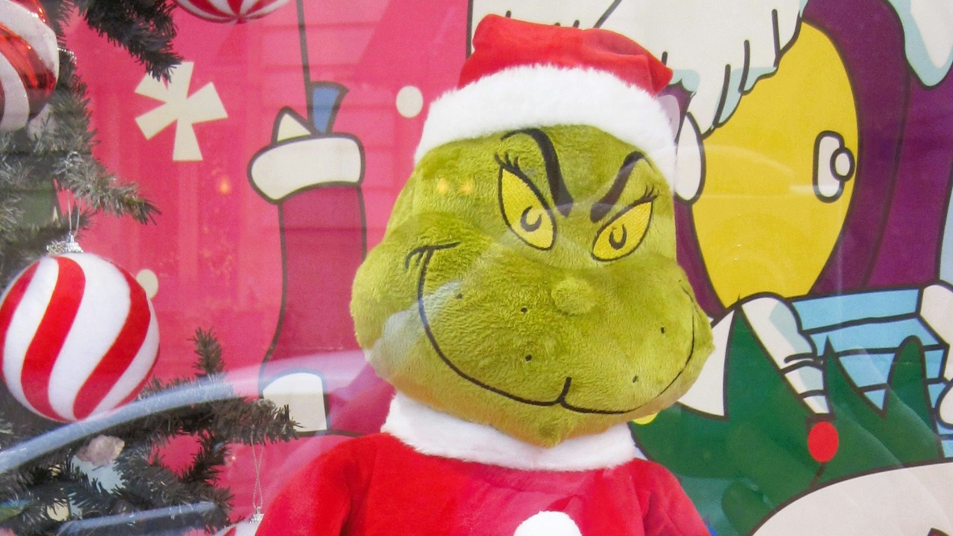 A christmas display with a cat in the hat holding a leash