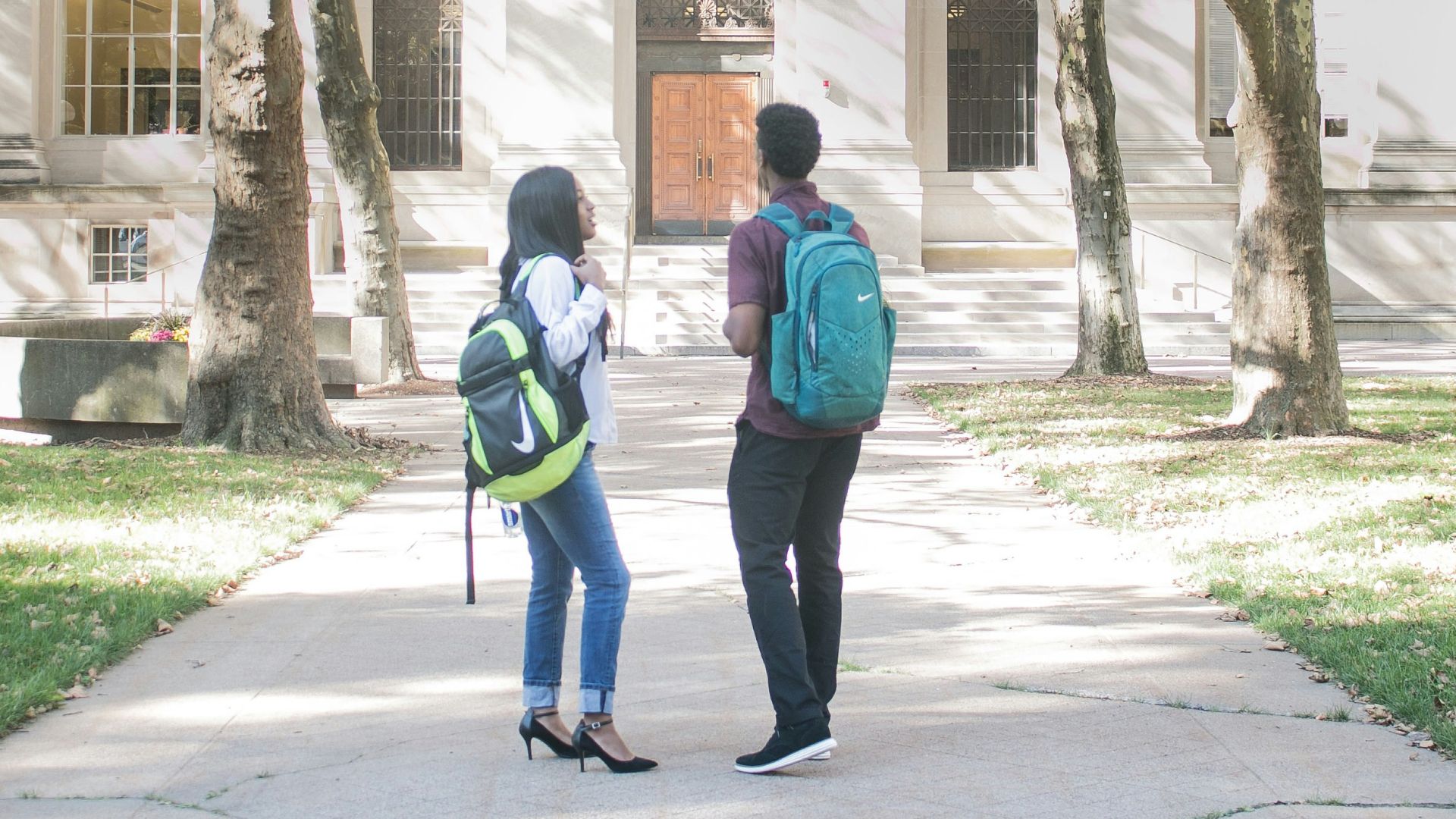 a couple of people that are standing in front of a building