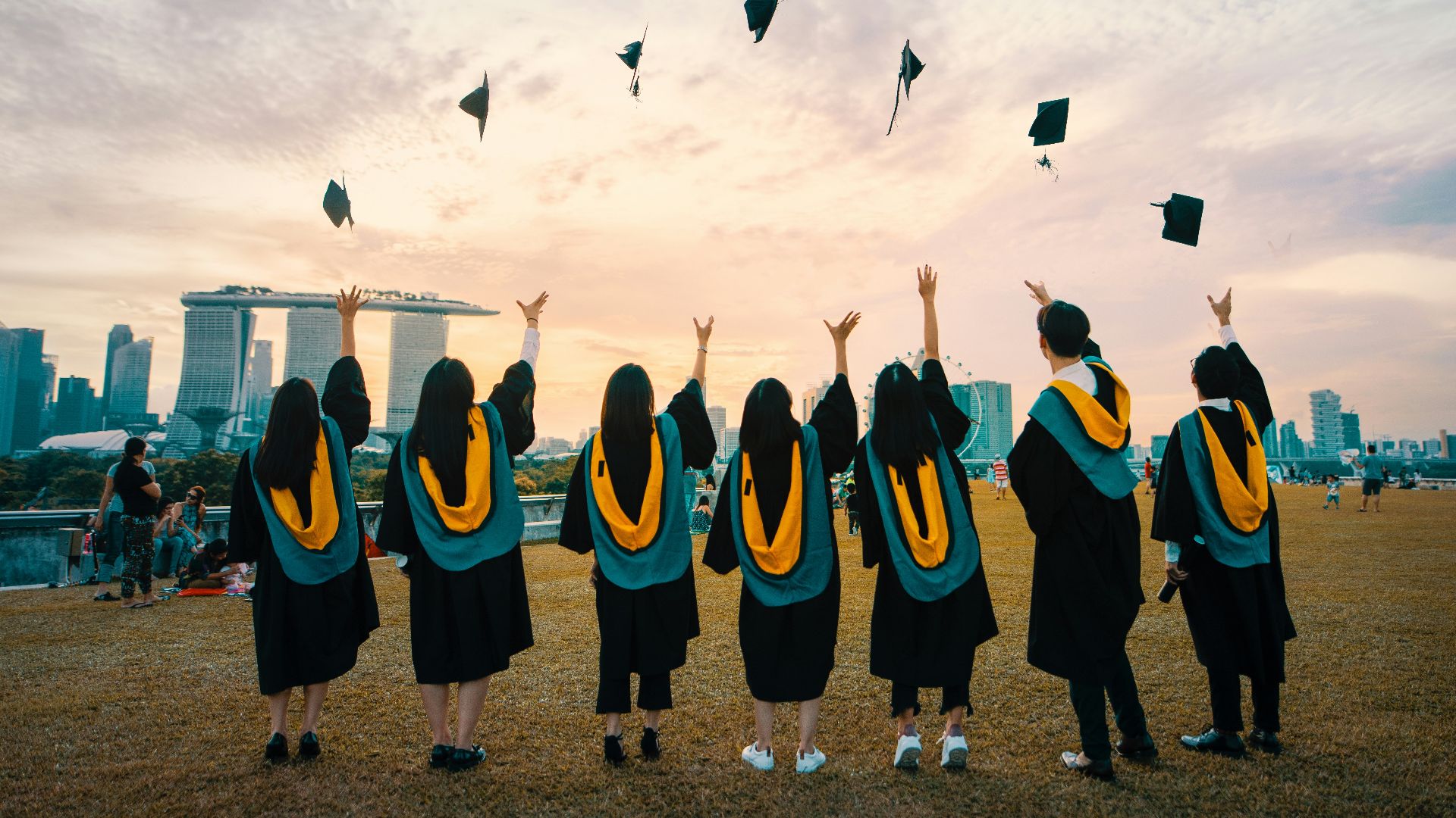 people throwing hats on air