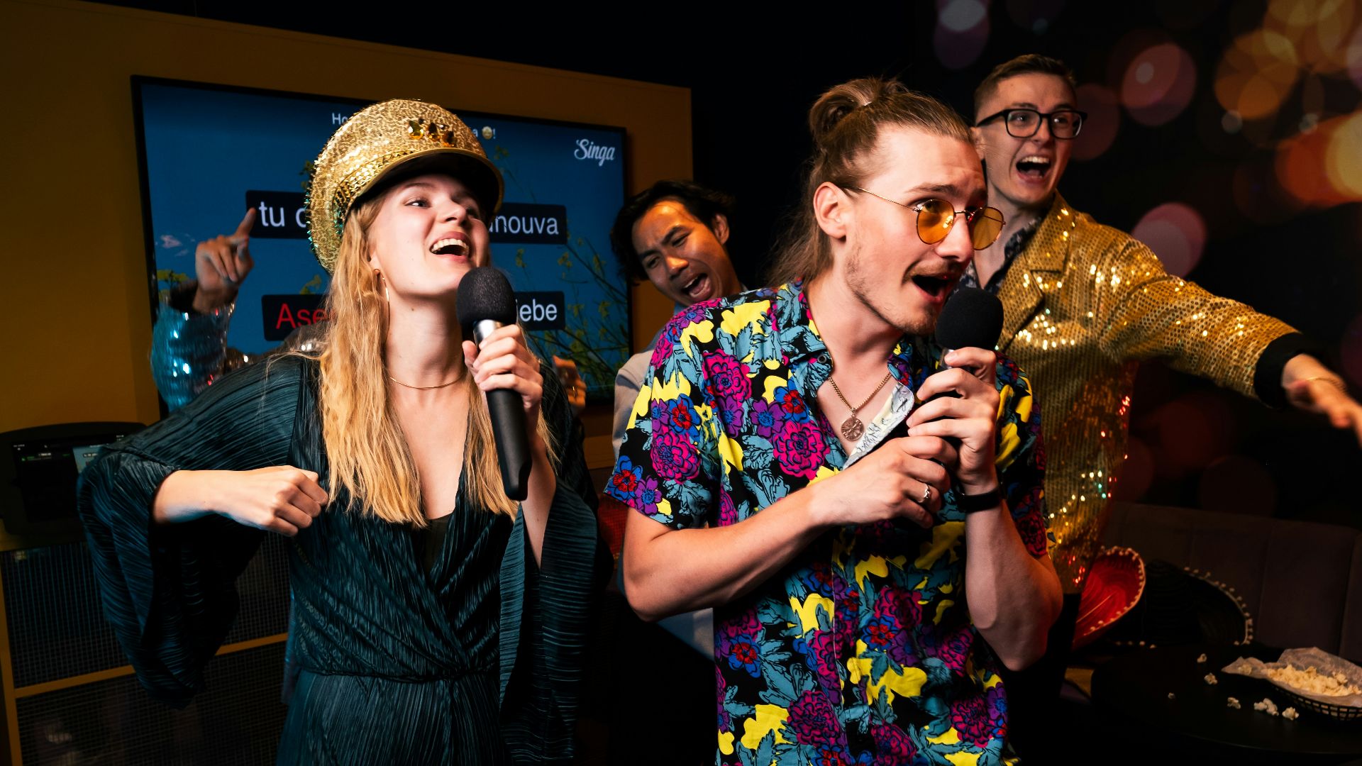 A group of people standing around each other in a room