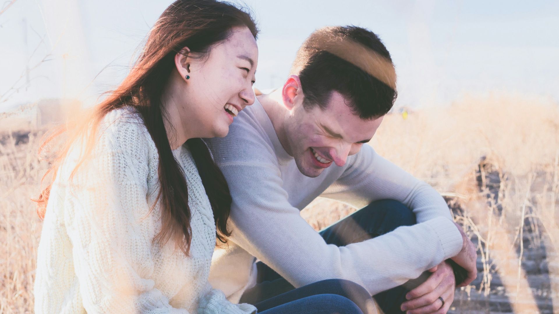 photo of man and woman laughing during daytime