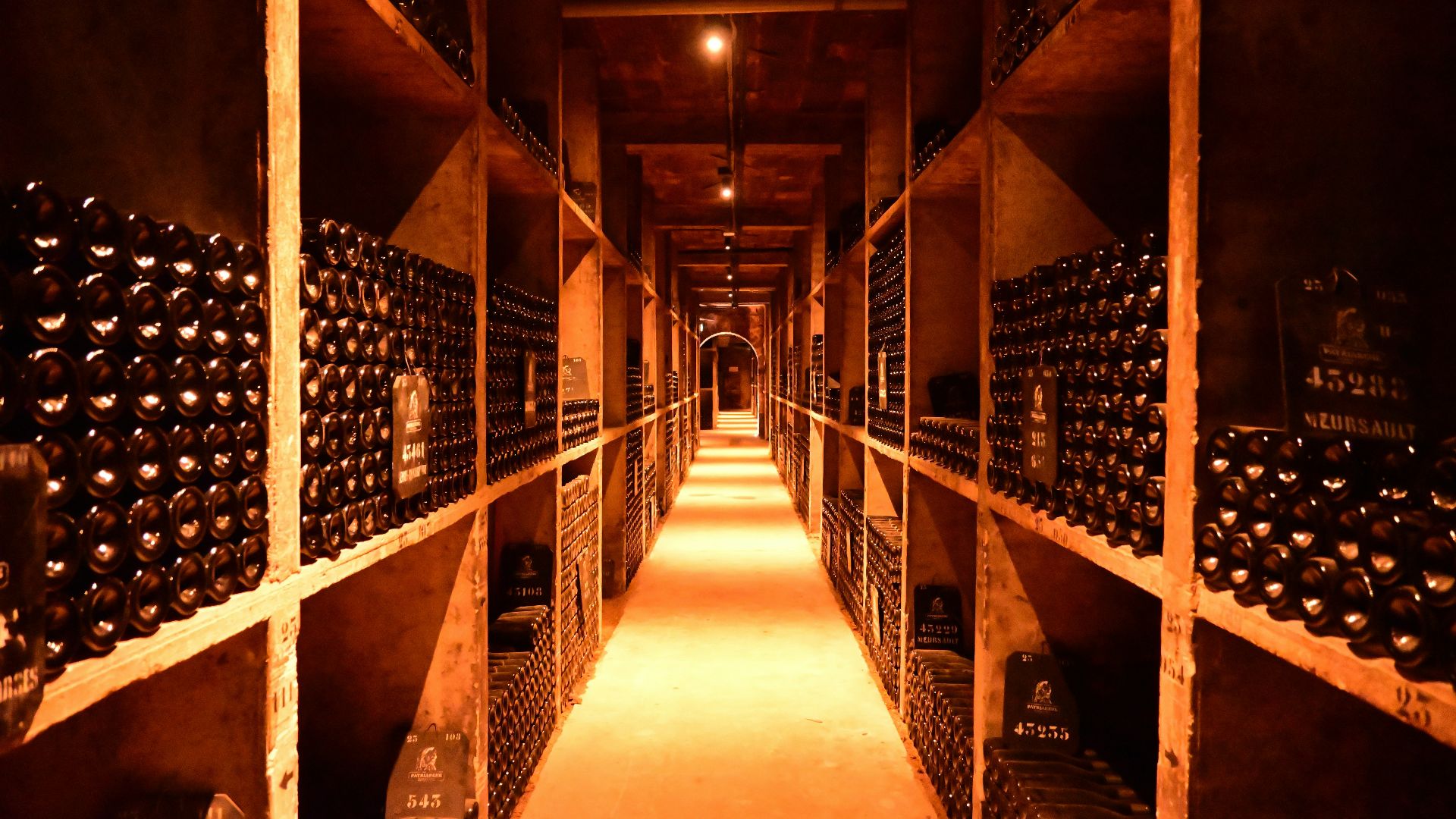 A long narrow room filled with lots of bottles