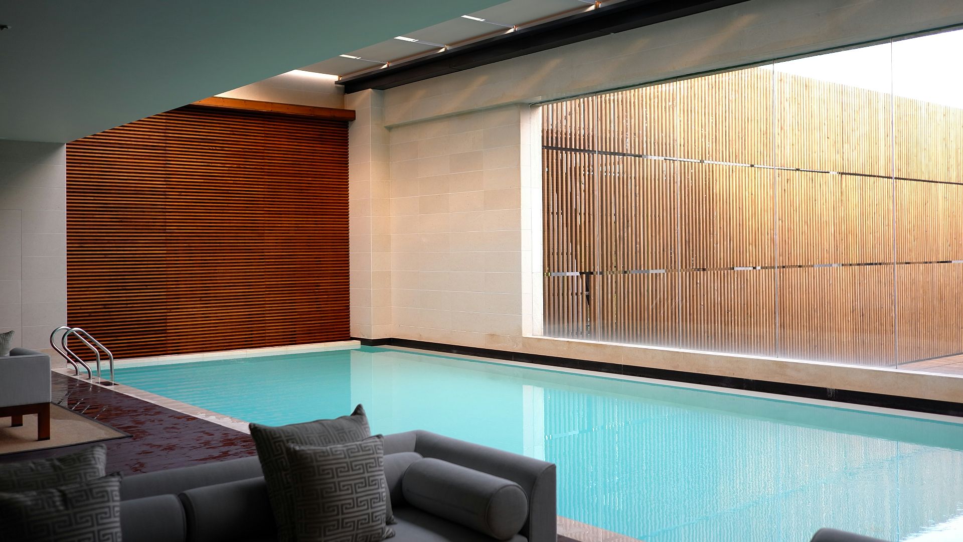 two gray sofas beside pool in room