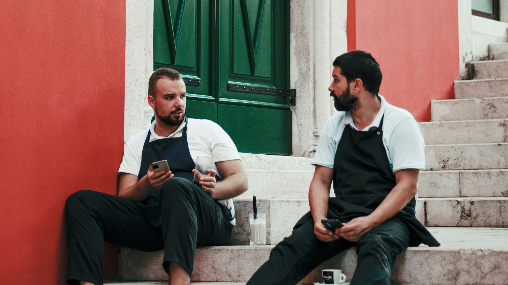 man in white dress shirt sitting on gray concrete bench