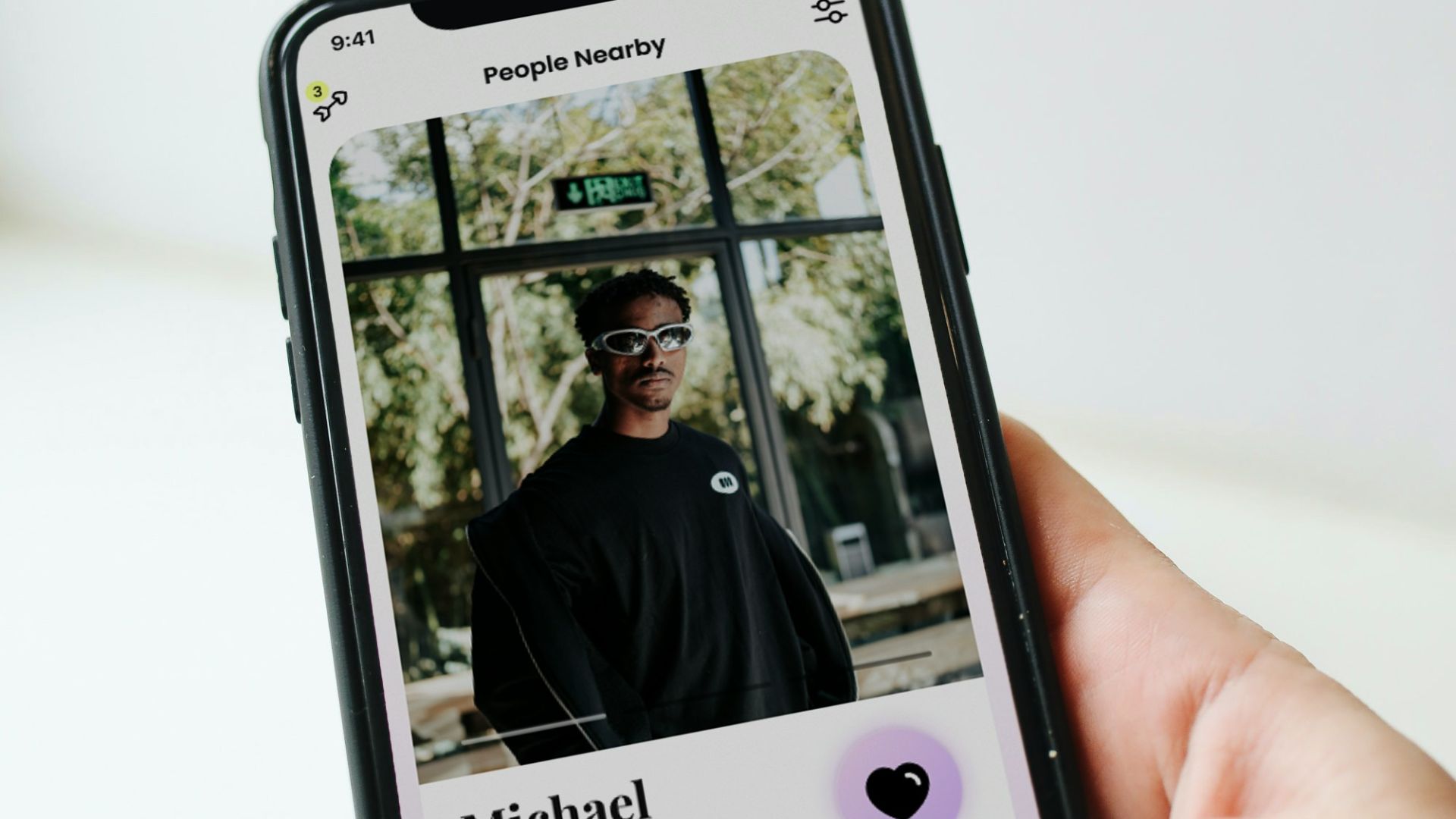 a person holding a cell phone with a picture of a man on it