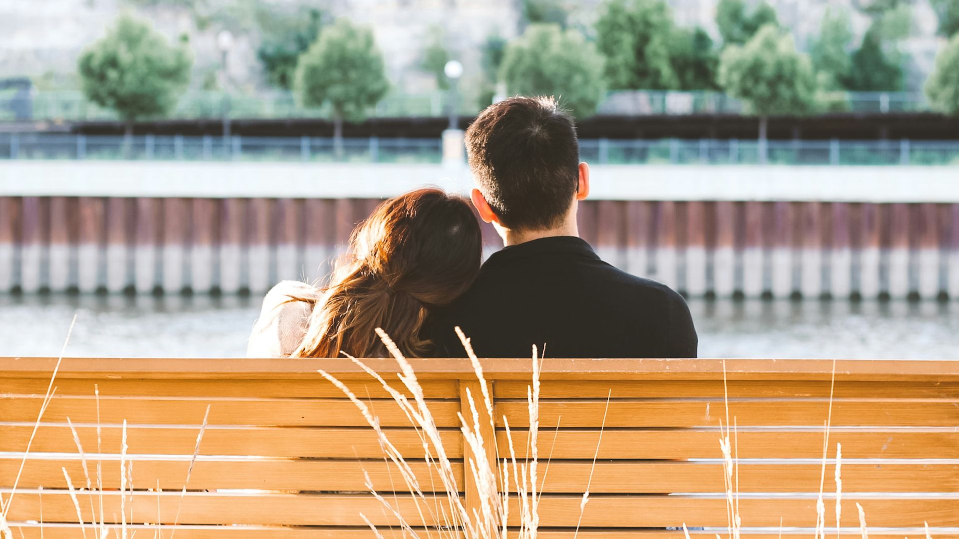 couple sitting on wooden bench