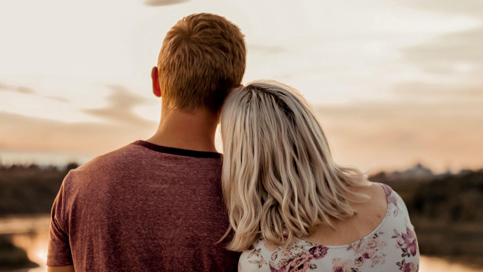 man and woman standing on brown field during daytime