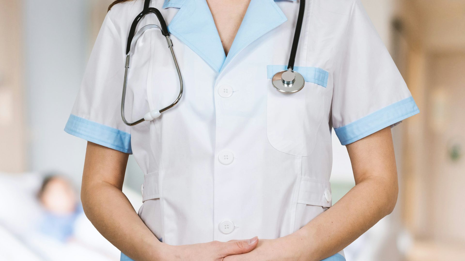 woman in white button up shirt and blue stethoscope