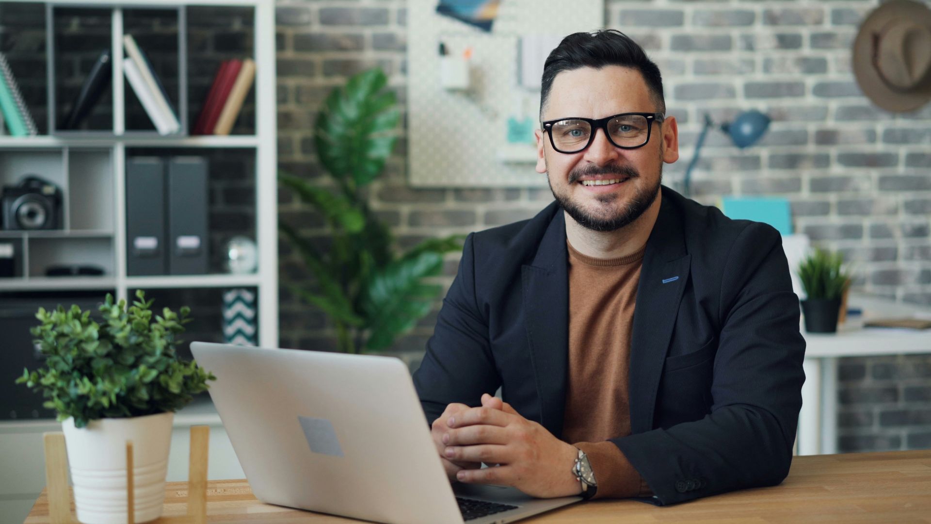 a man sitting at a table with a laptop