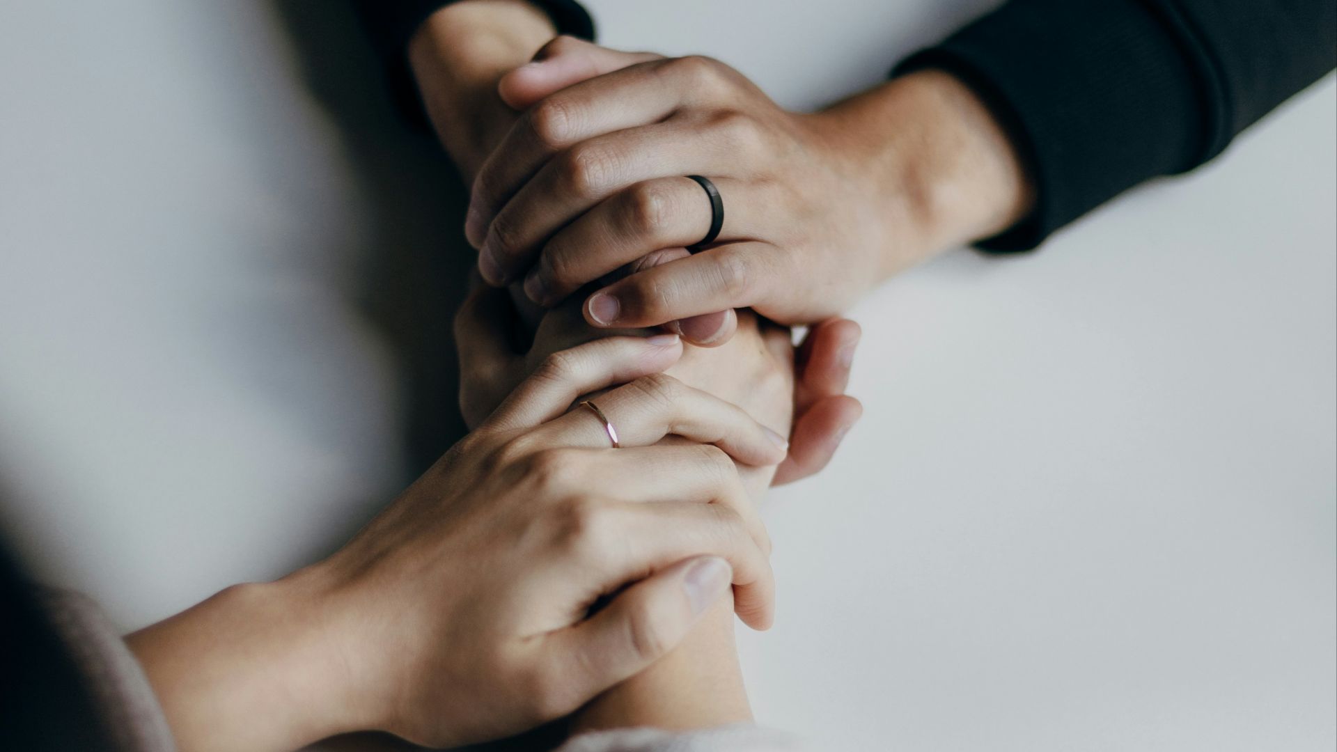 person in black long sleeve shirt holding babys feet