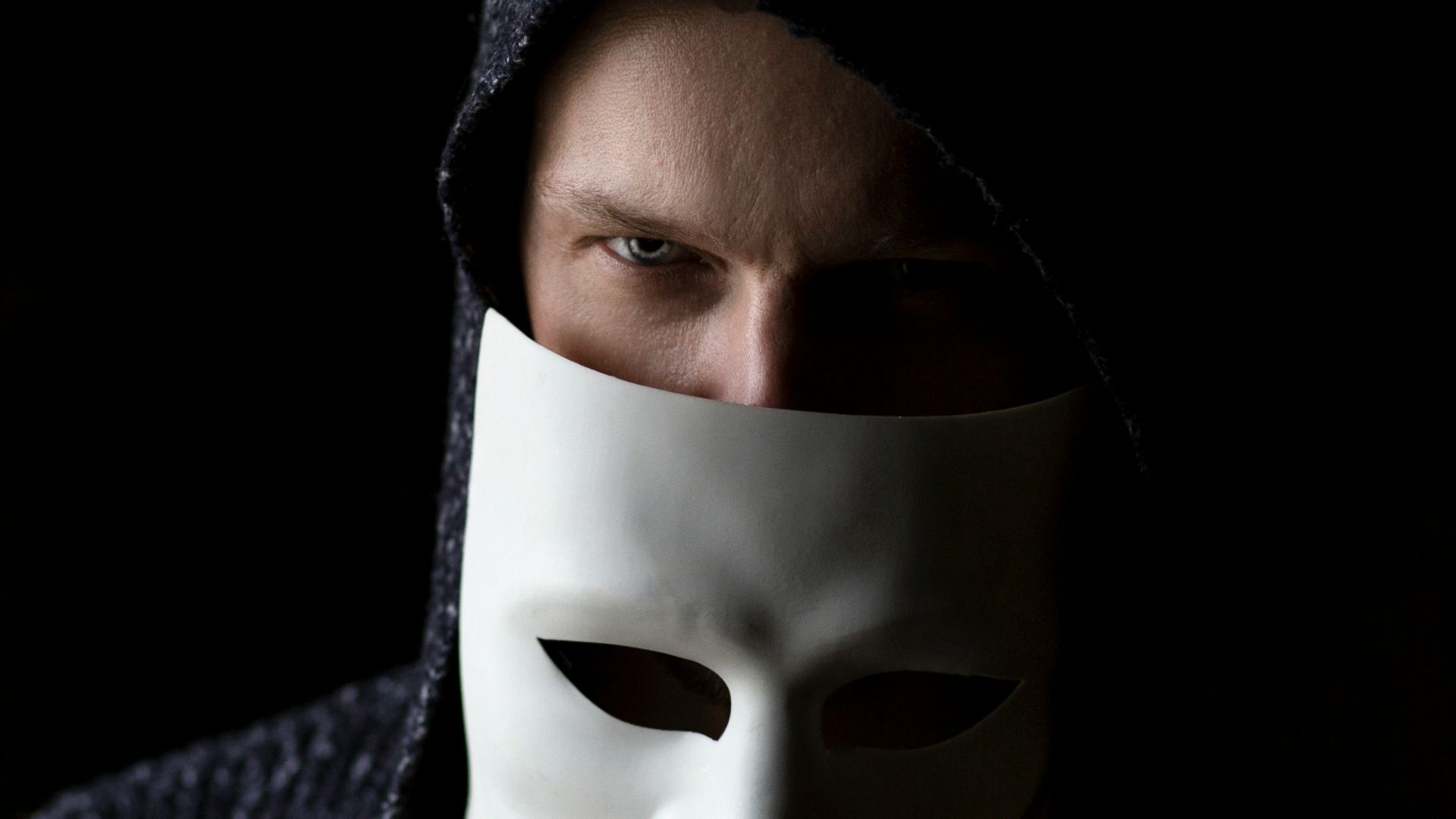 person in black knit cap and gray sweater