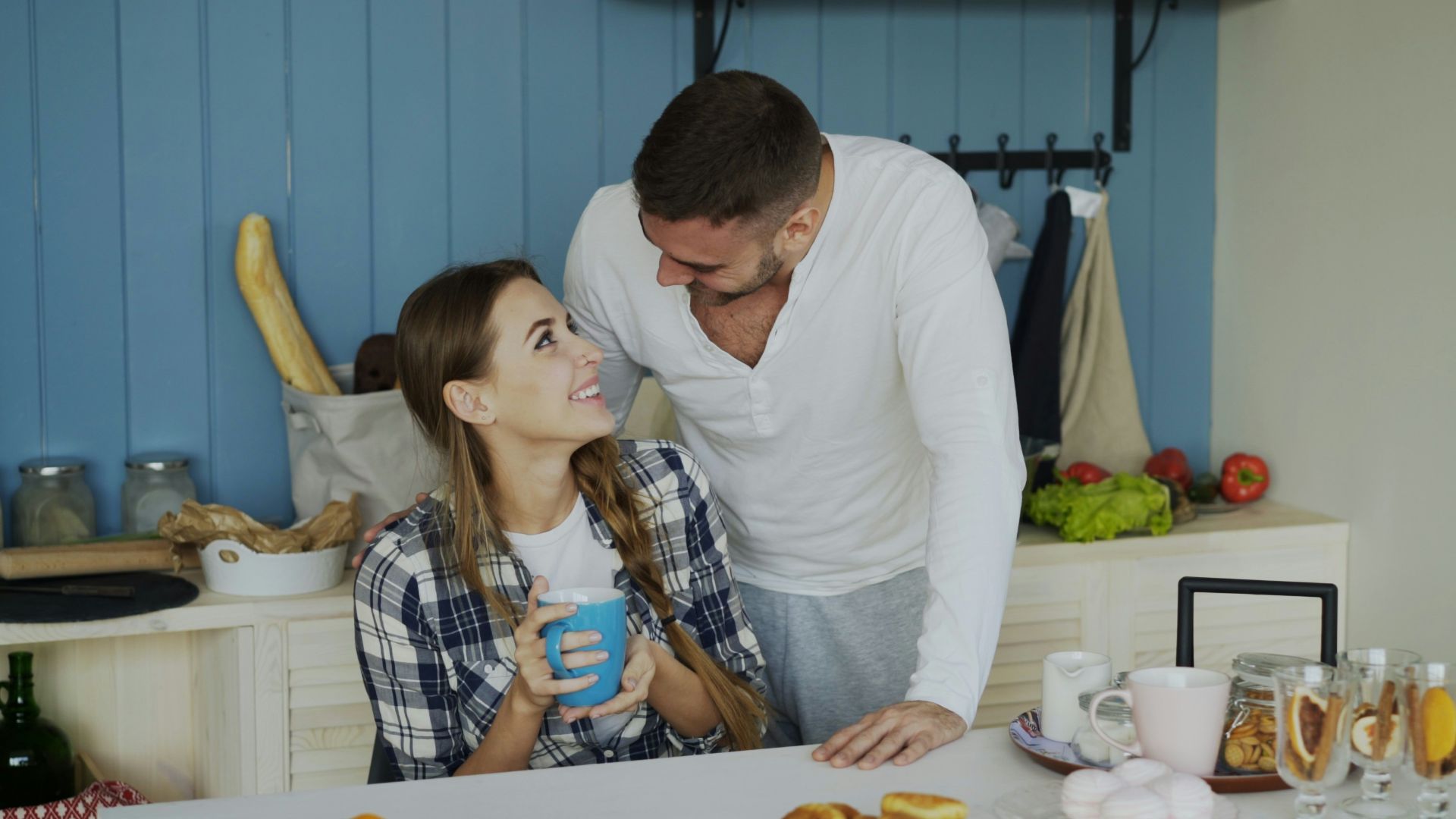 Couple sharing a morning moment in the kitchen.