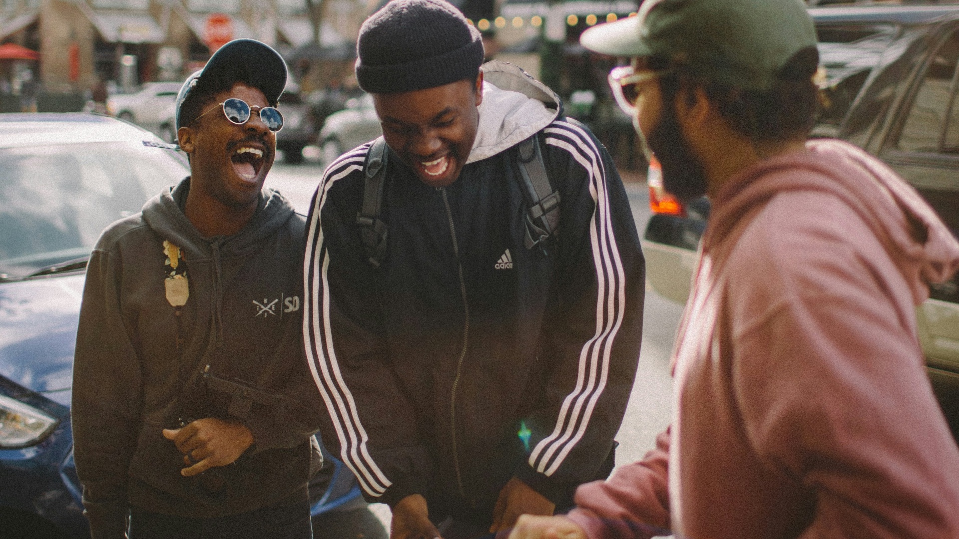 three men in jacket laughing at each other