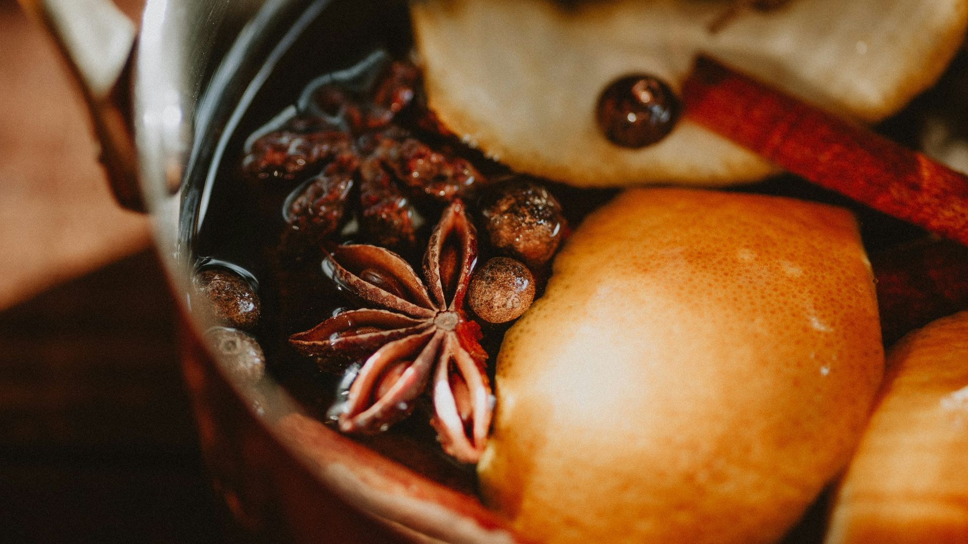 a pot filled with fruit and nuts on top of a table