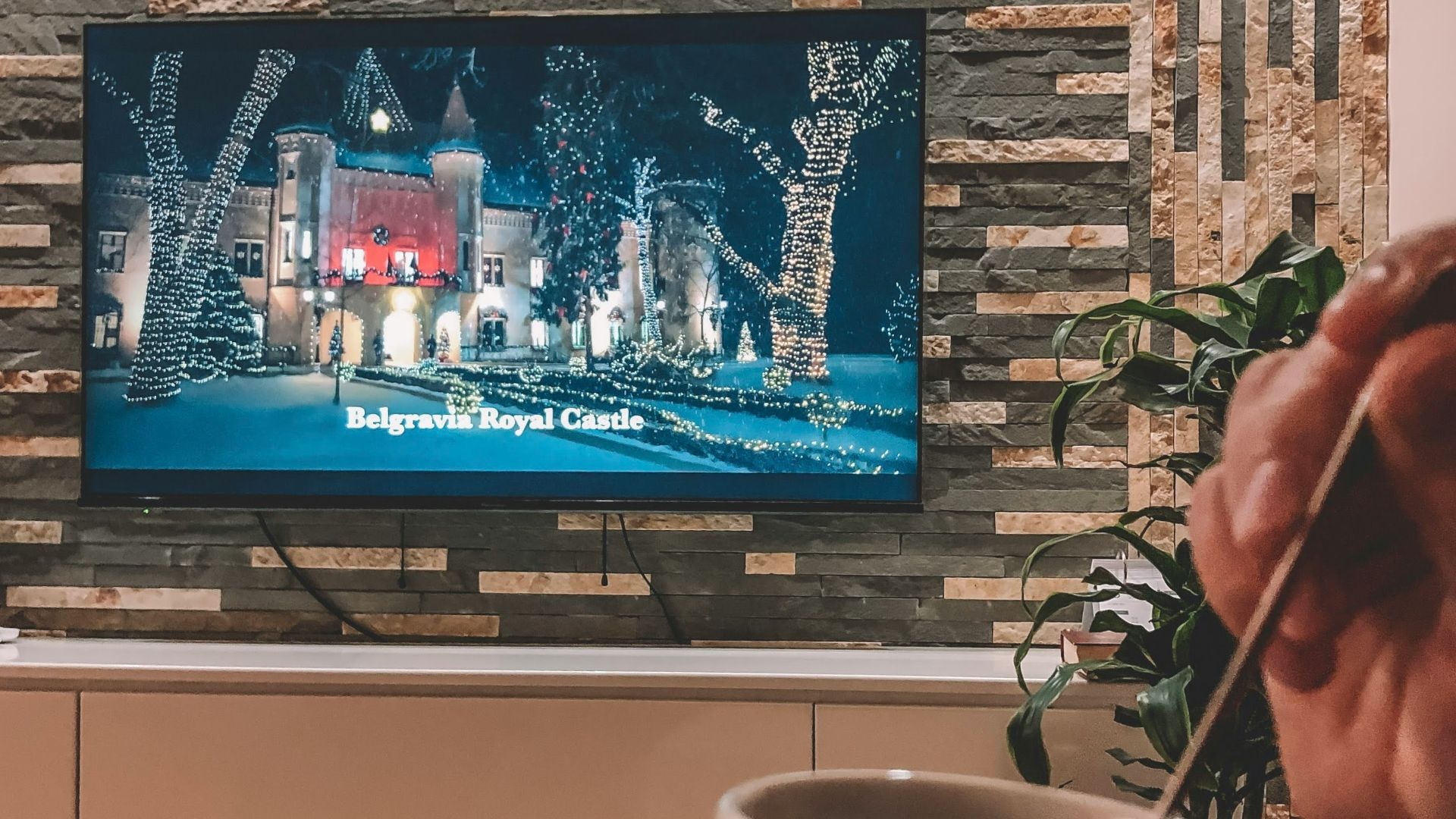 white ceramic mug near black flat screen tv