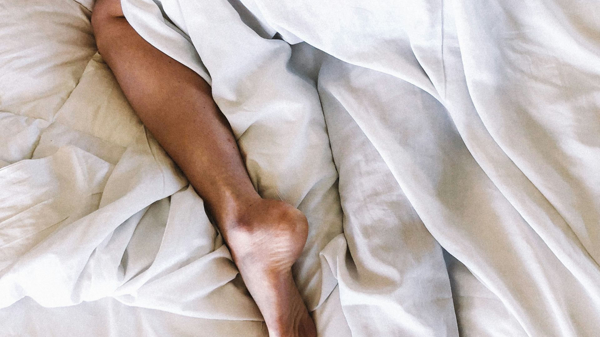 woman covered with white blanket