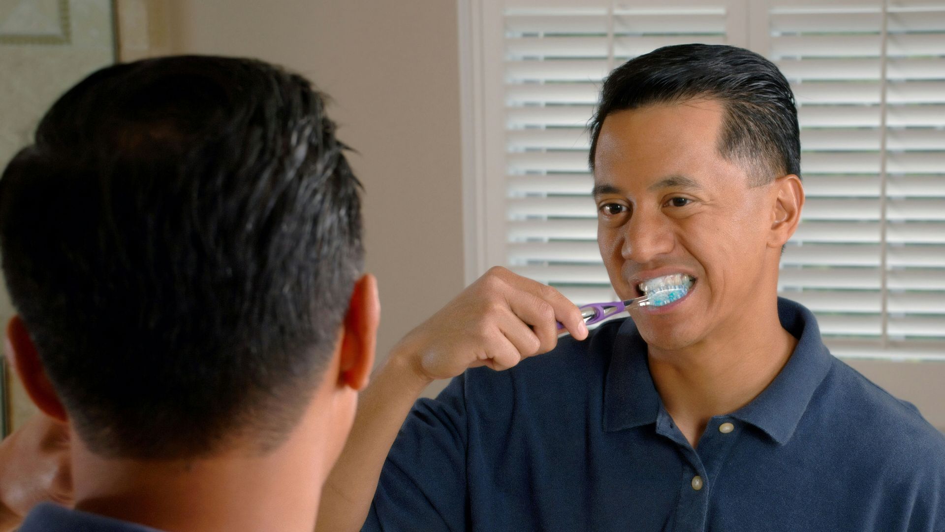 man in blue polo shirt smoking cigarette