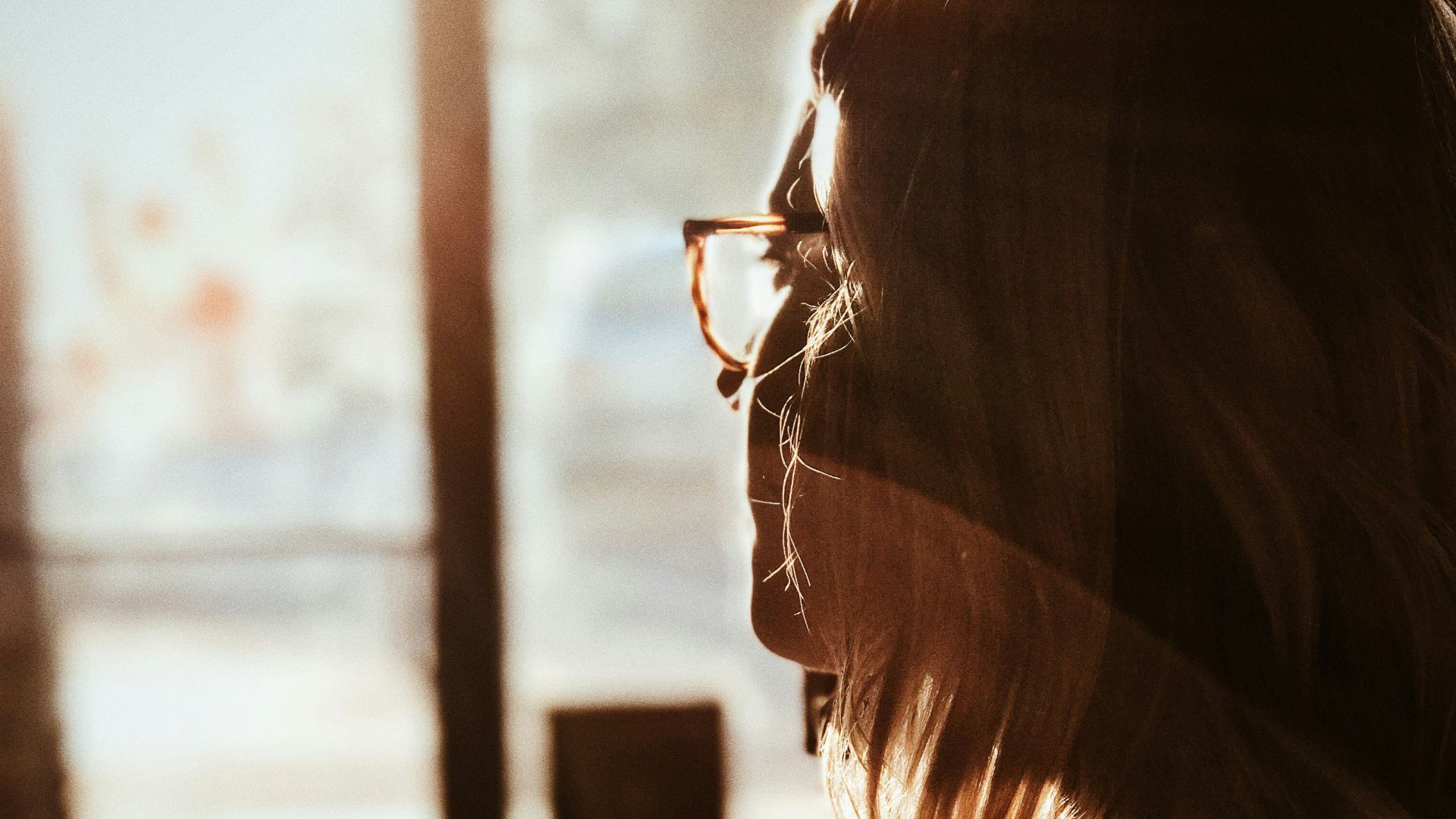 shallow focus photography of woman facing door