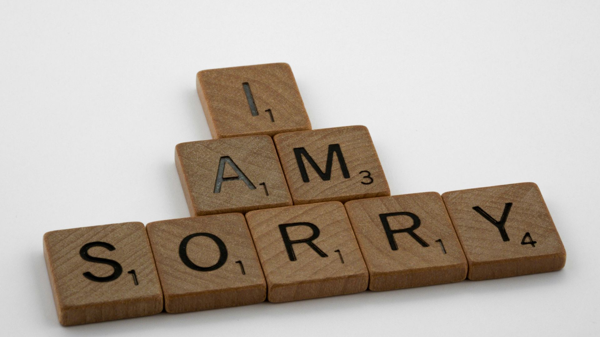 brown wooden letter blocks on white surface