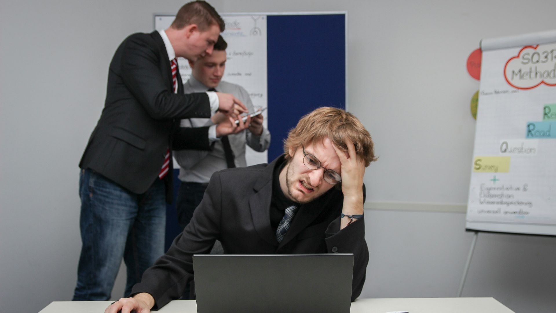 A man sitting in front of a laptop computer