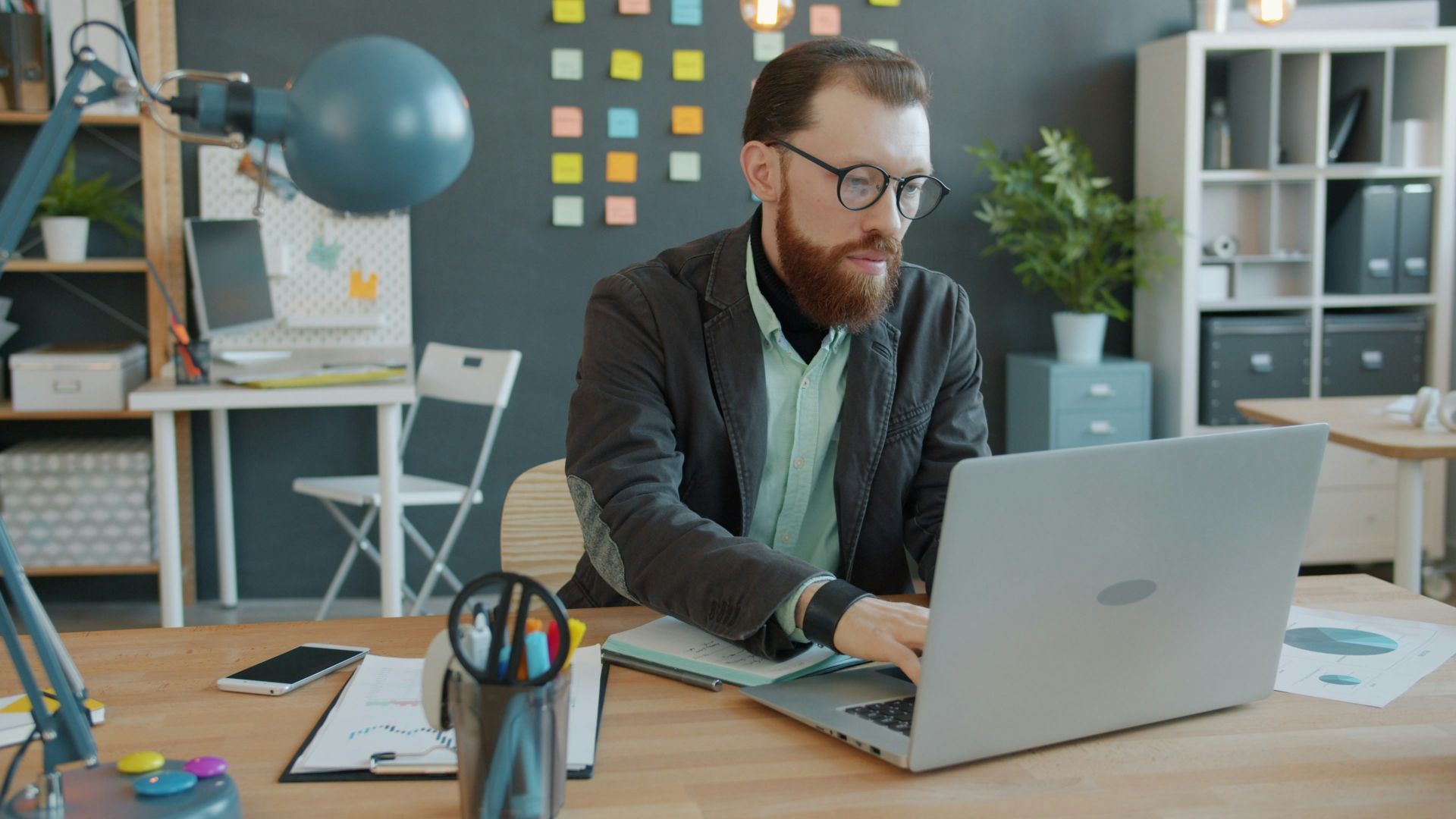 Man working on laptop in modern office