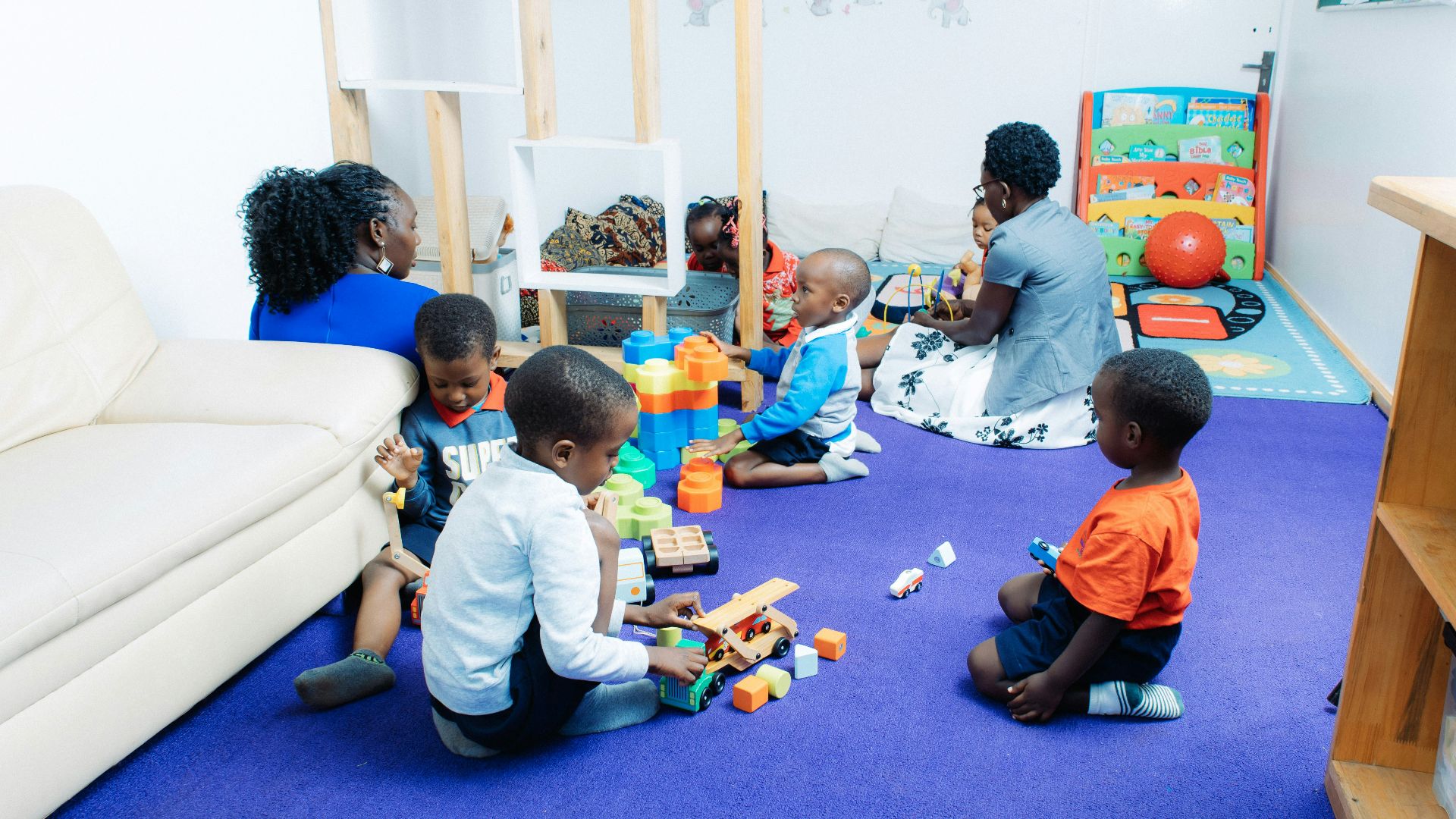 Children playing with toys in a bright room.
