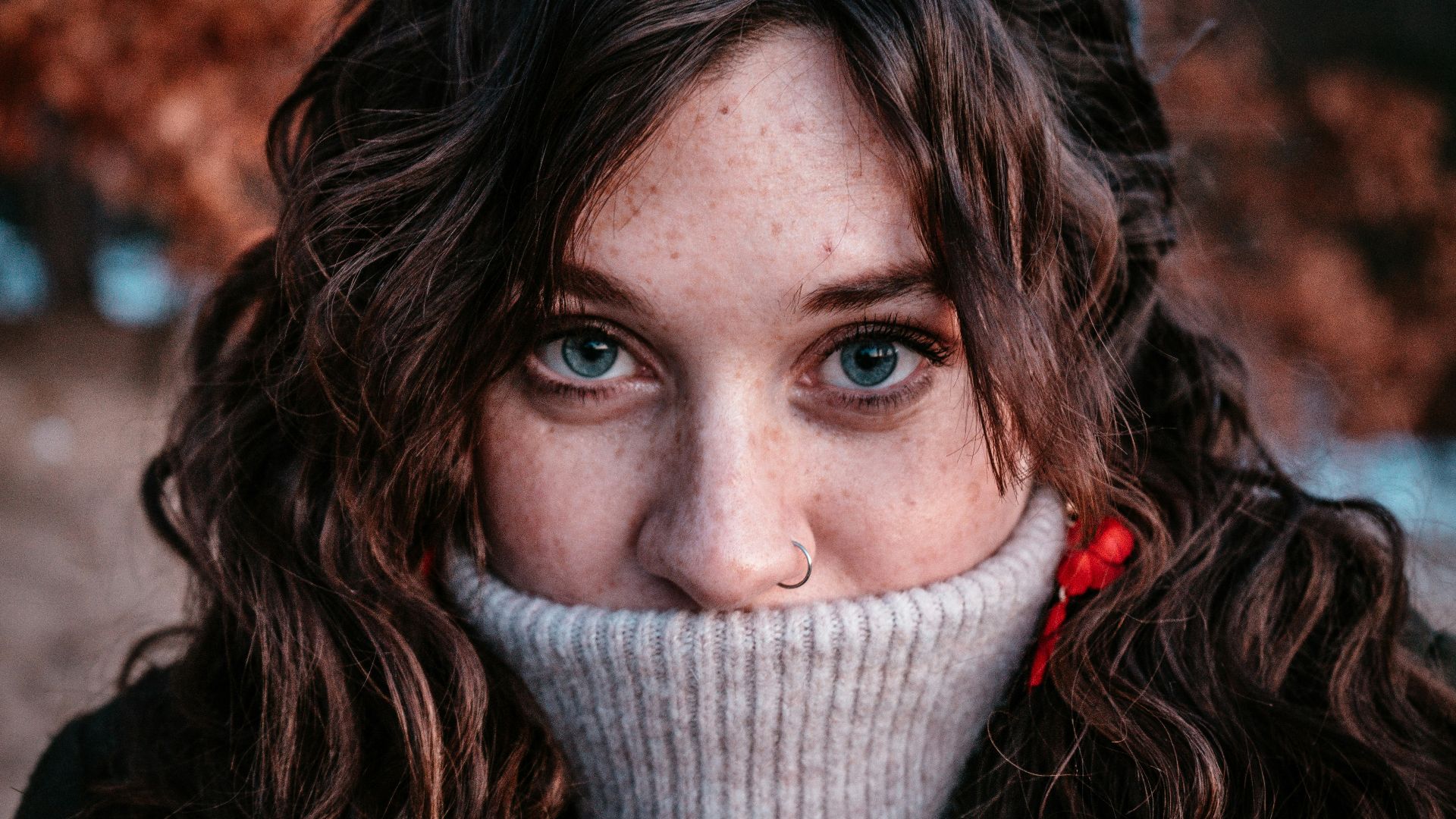 portrait photograph of woman in gray sweater
