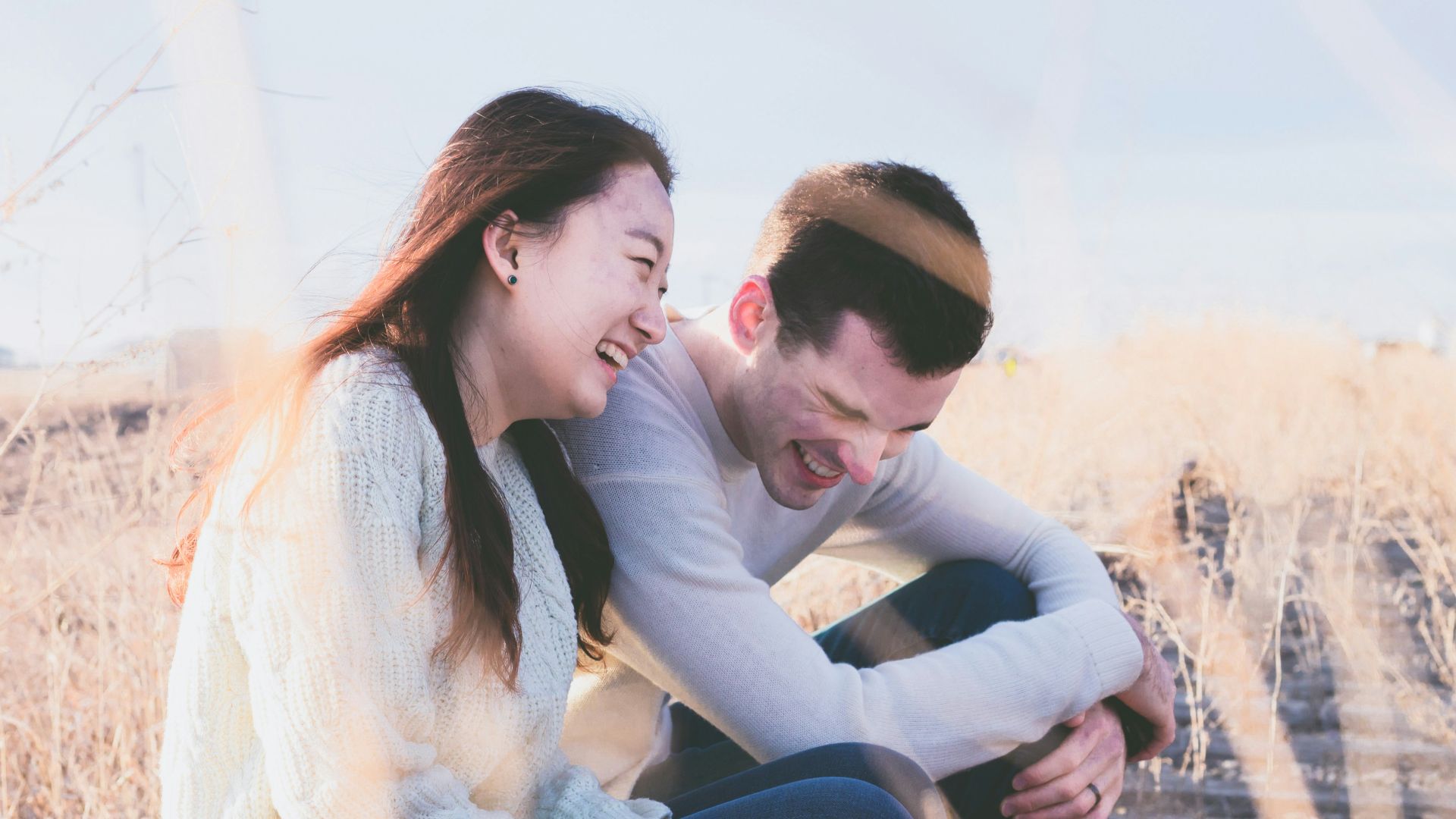 photo of man and woman laughing during daytime