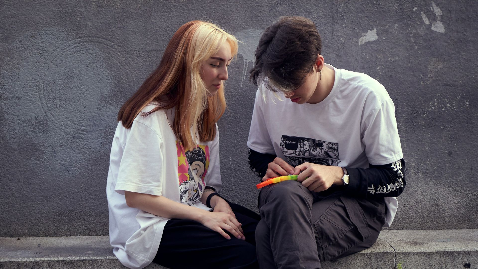 man in white crew neck t-shirt sitting beside woman in white crew neck t-shirt
