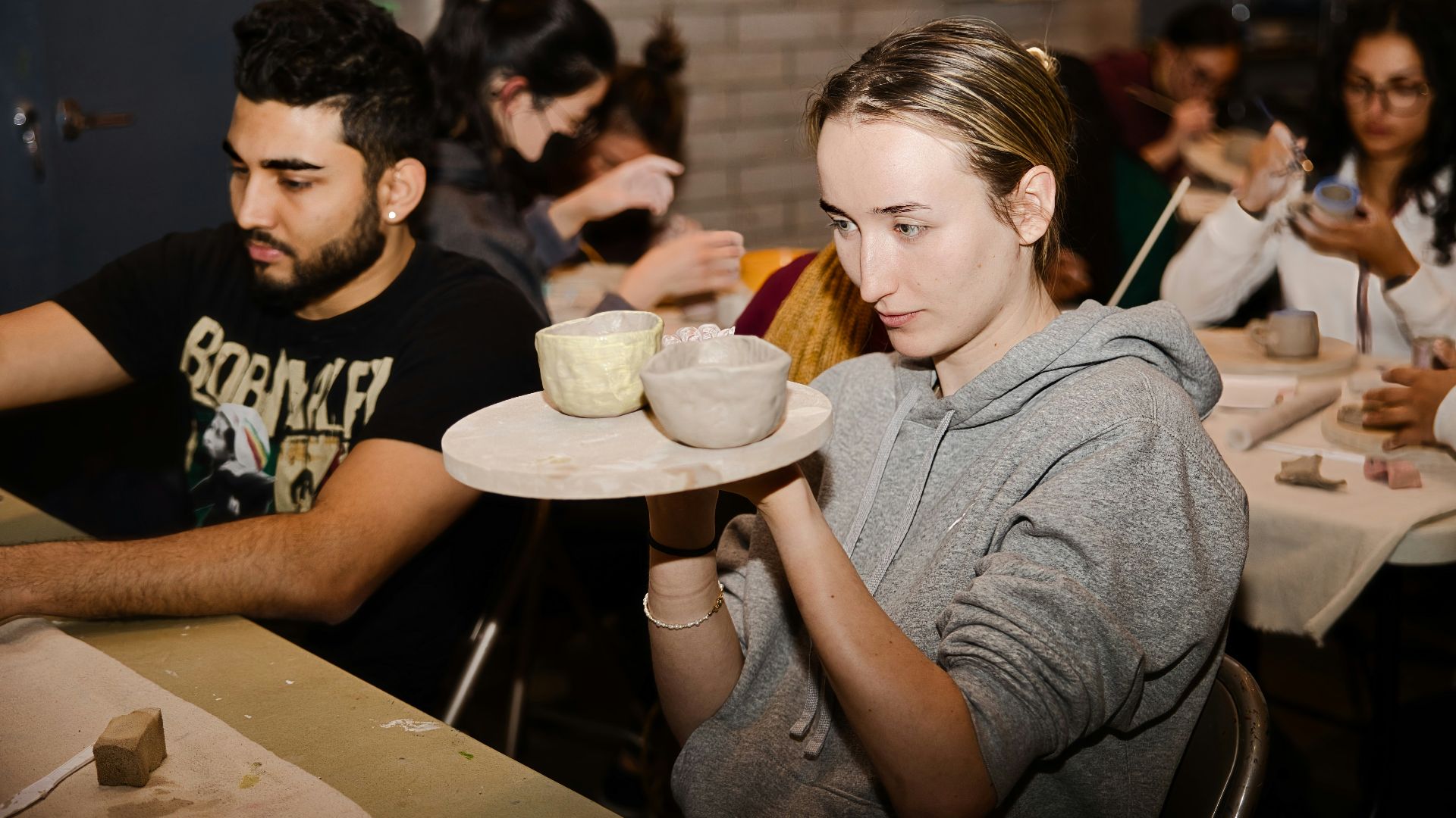 a woman holding a plate with a bowl on it