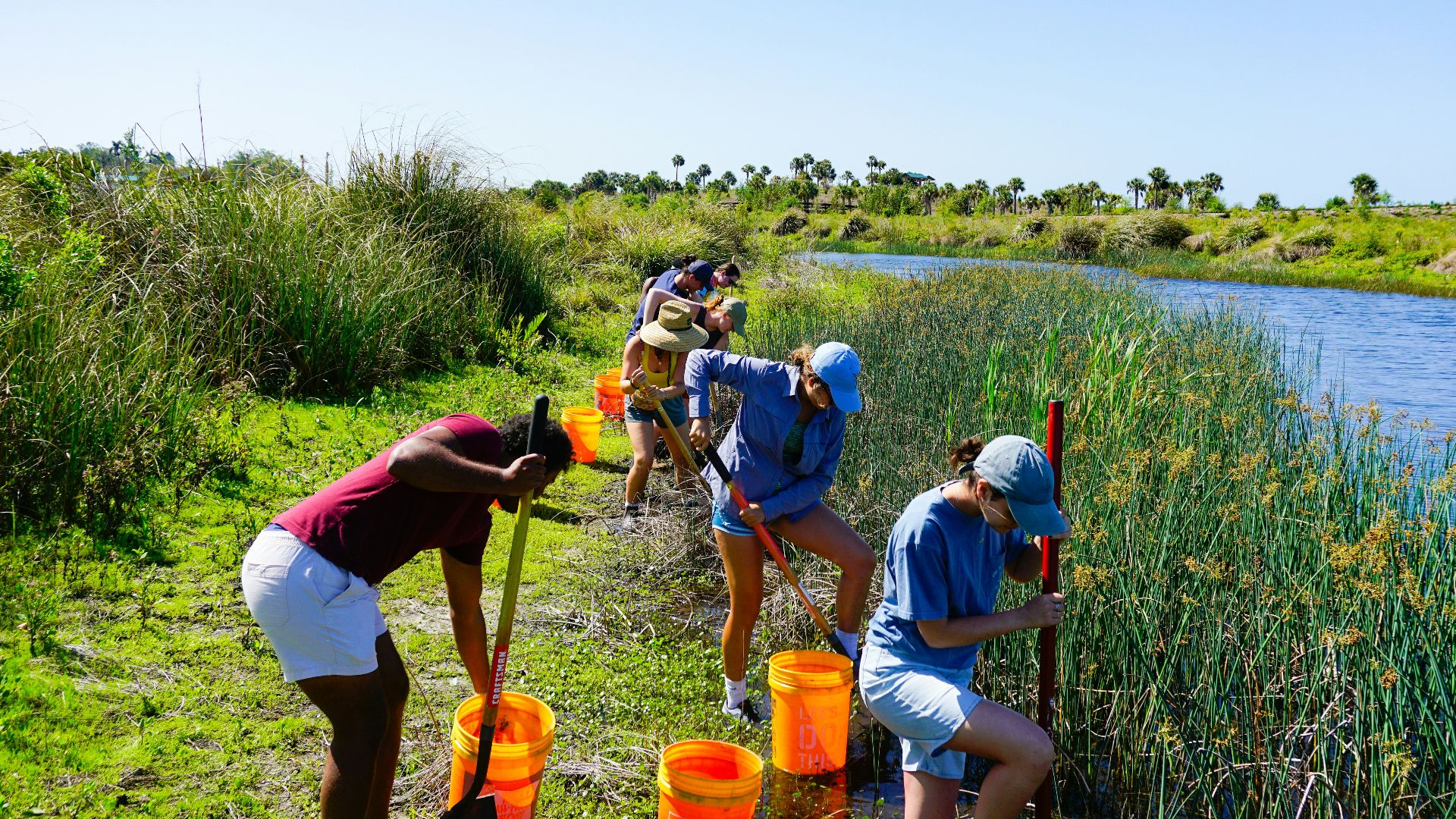 a group of people standing next to a river