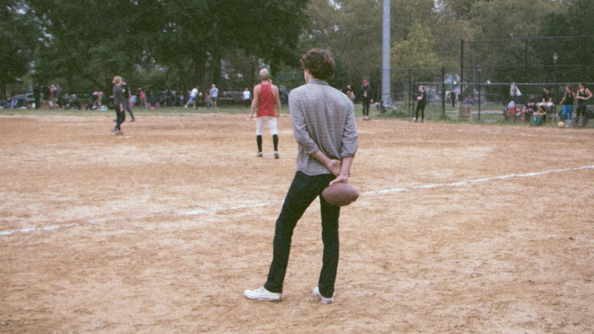 man in white shirt and black pants playing basketball during daytime