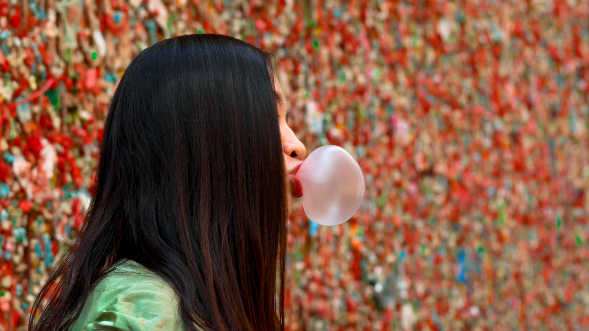 woman in green jacket looking at the sky