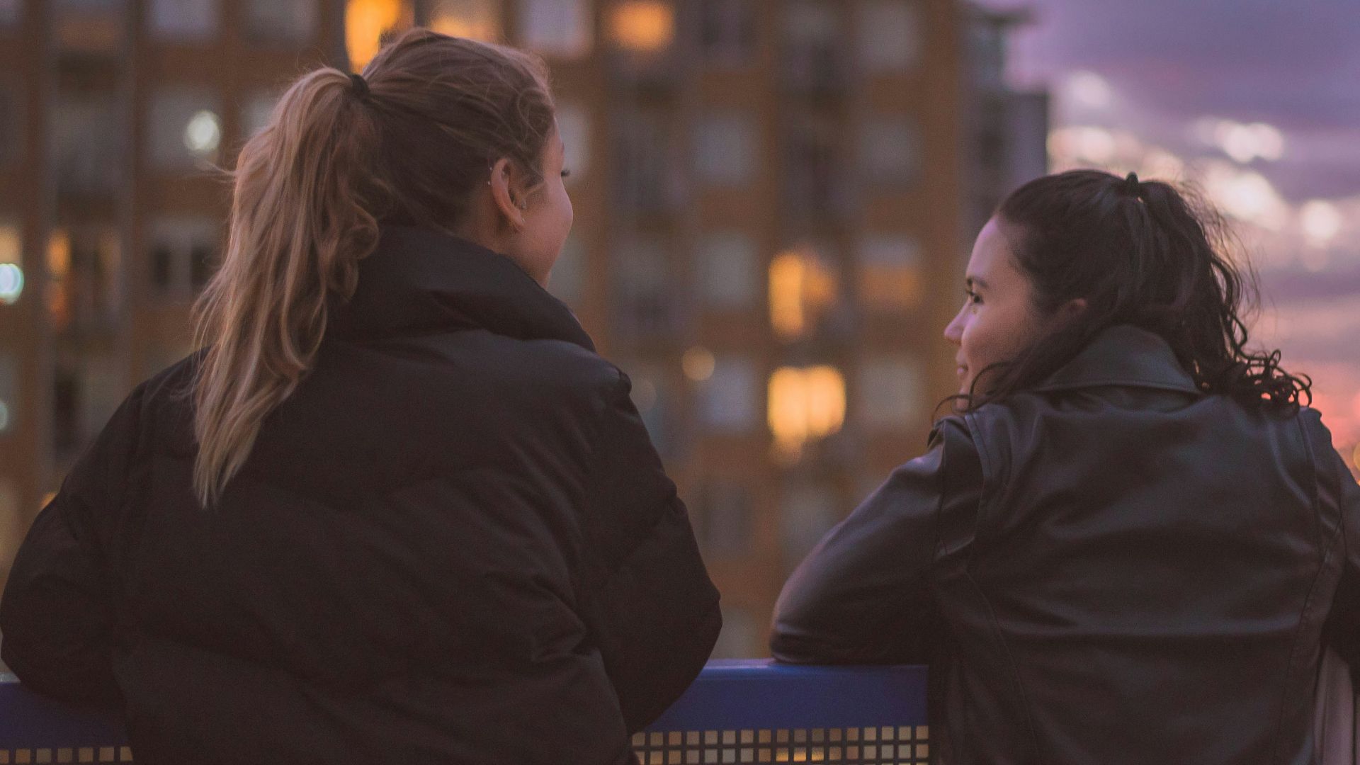 two women standing near railings