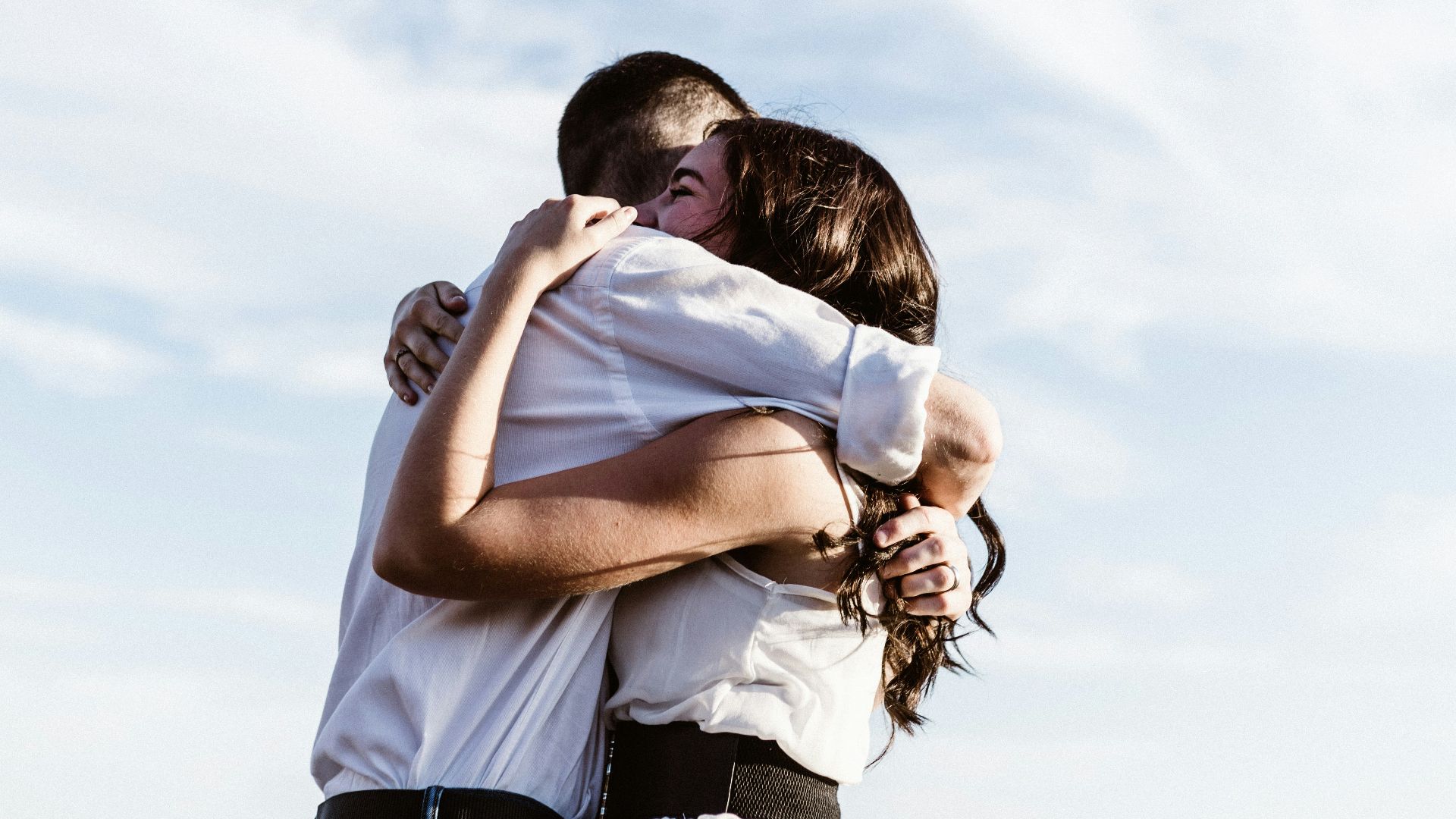 man and woman hugging each other photography