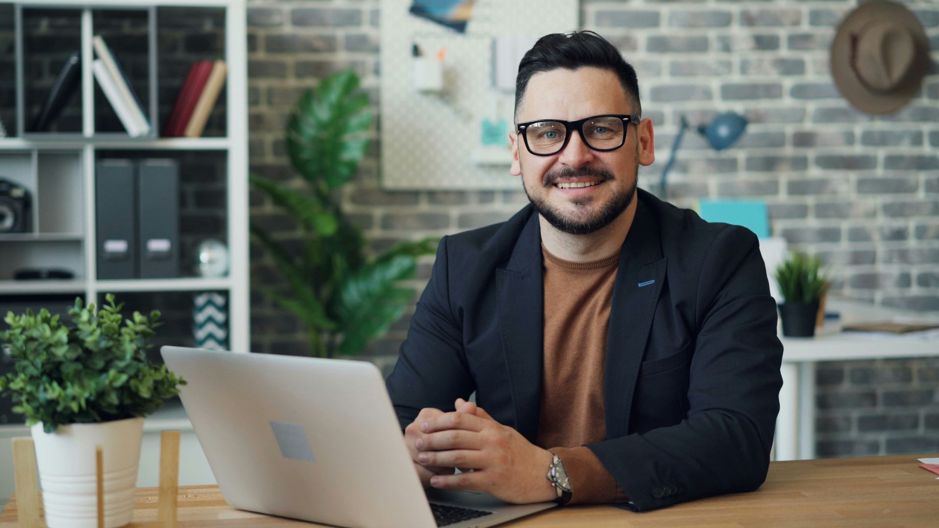 a man sitting at a table with a laptop
